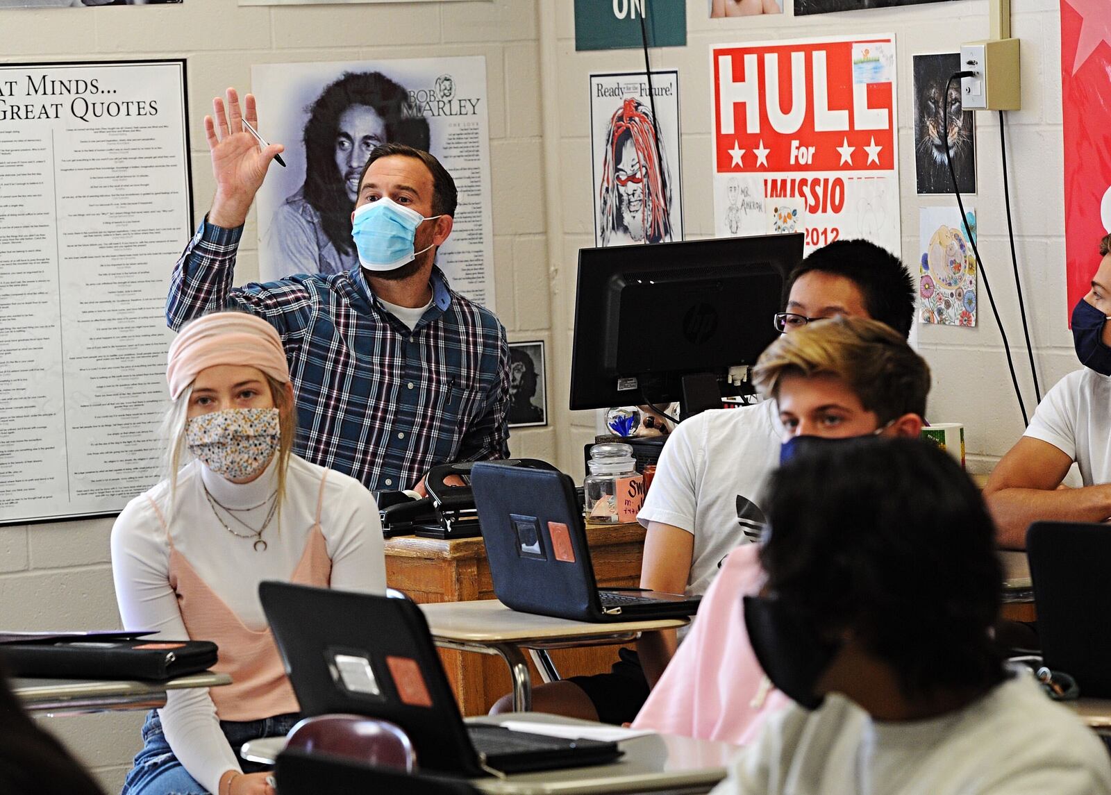 A Beavercreek High School teacher works with students on Oct. 8, 2020.