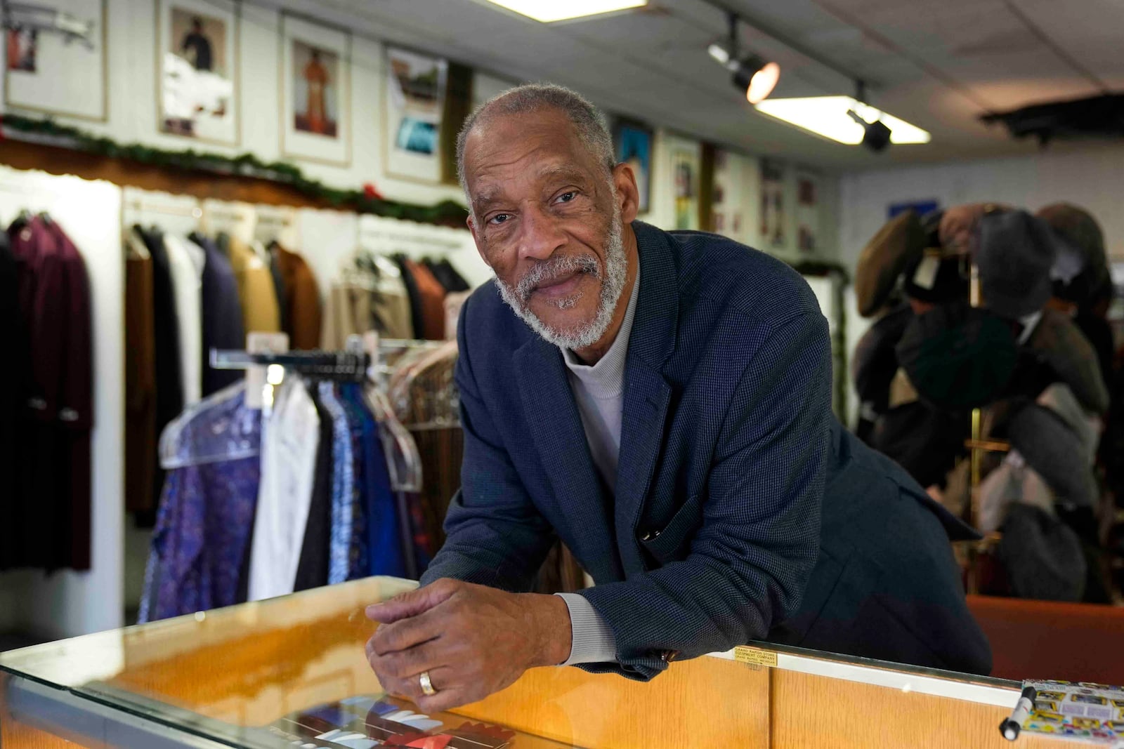 Ledall Edwards stands inside his family's men's clothing store, Edward's Fashions, which his father opened 50 years ago with the hopes of a southern Red Line train line expansion, Thursday, Dec. 19, 2024, in the Roseland neighborhood of Chicago. (AP Photo/Erin Hooley)