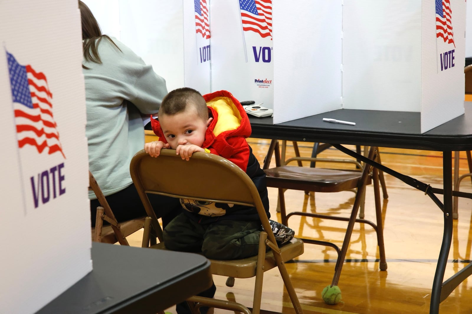 Three-year-old Kyle Snyder looks around the  voting poll as his mother casts her vote Tuesday, March 19, 2024 at Tecumseh High School. BILL LACKEY/STAFF