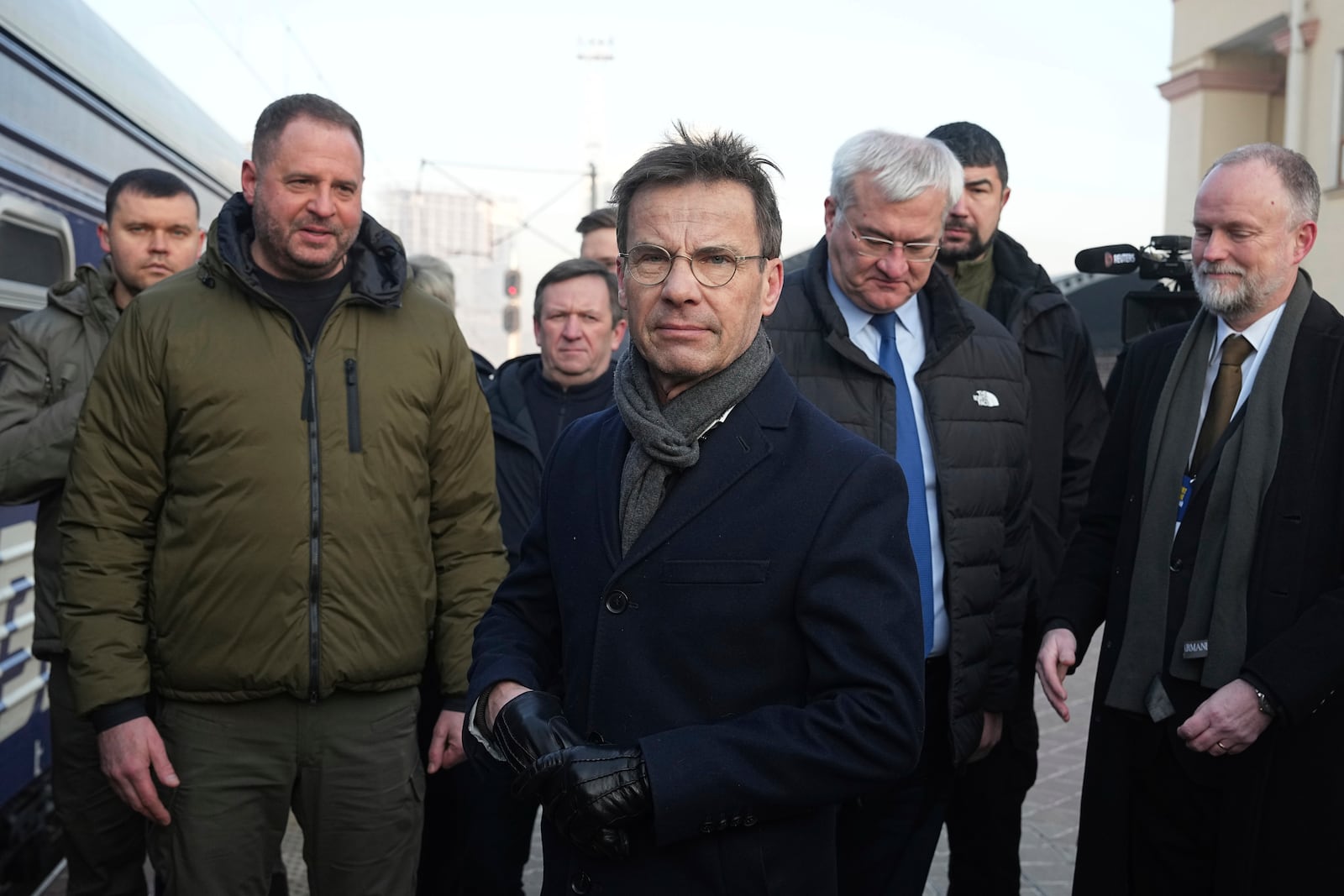 Sweden's Prime Minister Ulf Kristersson, center, arrives at a train station on the third anniversary of the Russian invasion of Ukraine, Kyiv, Ukraine, Monday, Feb. 24, 2025. (AP Photo/Efrem Lukatsky)