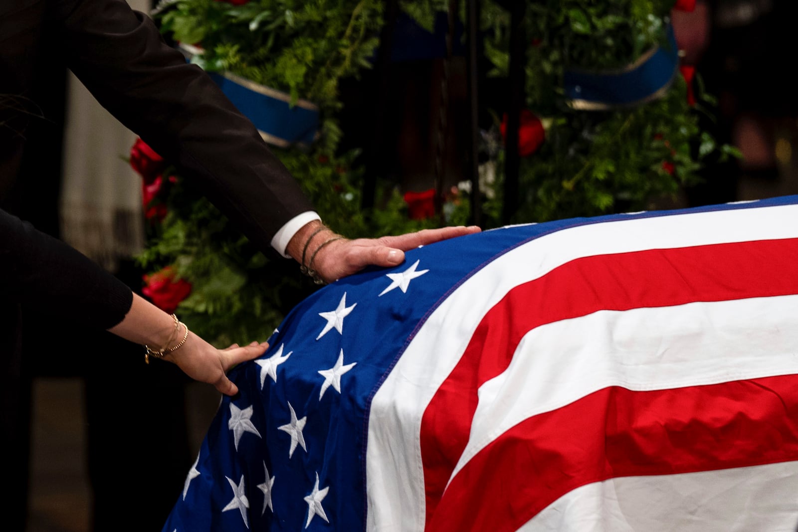 The Carter family pay their respects during a ceremony as the flag-draped casket of former President Jimmy Carter lies in state, at the Capitol, Tuesday, Jan. 7, 2025, in Washington. Carter died Dec. 29 at the age of 100. (Kent Nishimura/The New York Times via AP, Pool)