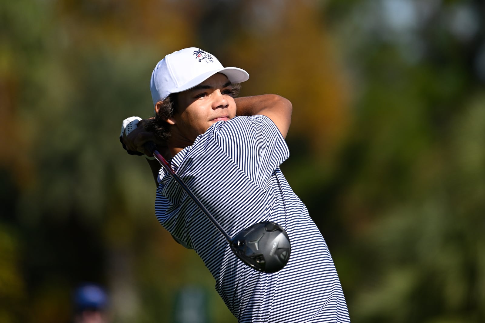 Charlie Woods tees off on the fifth hole during the first round of the PNC Championship golf tournament, Saturday, Dec. 21, 2024 in Orlando. (AP Photo/Phelan M. Ebenhack)