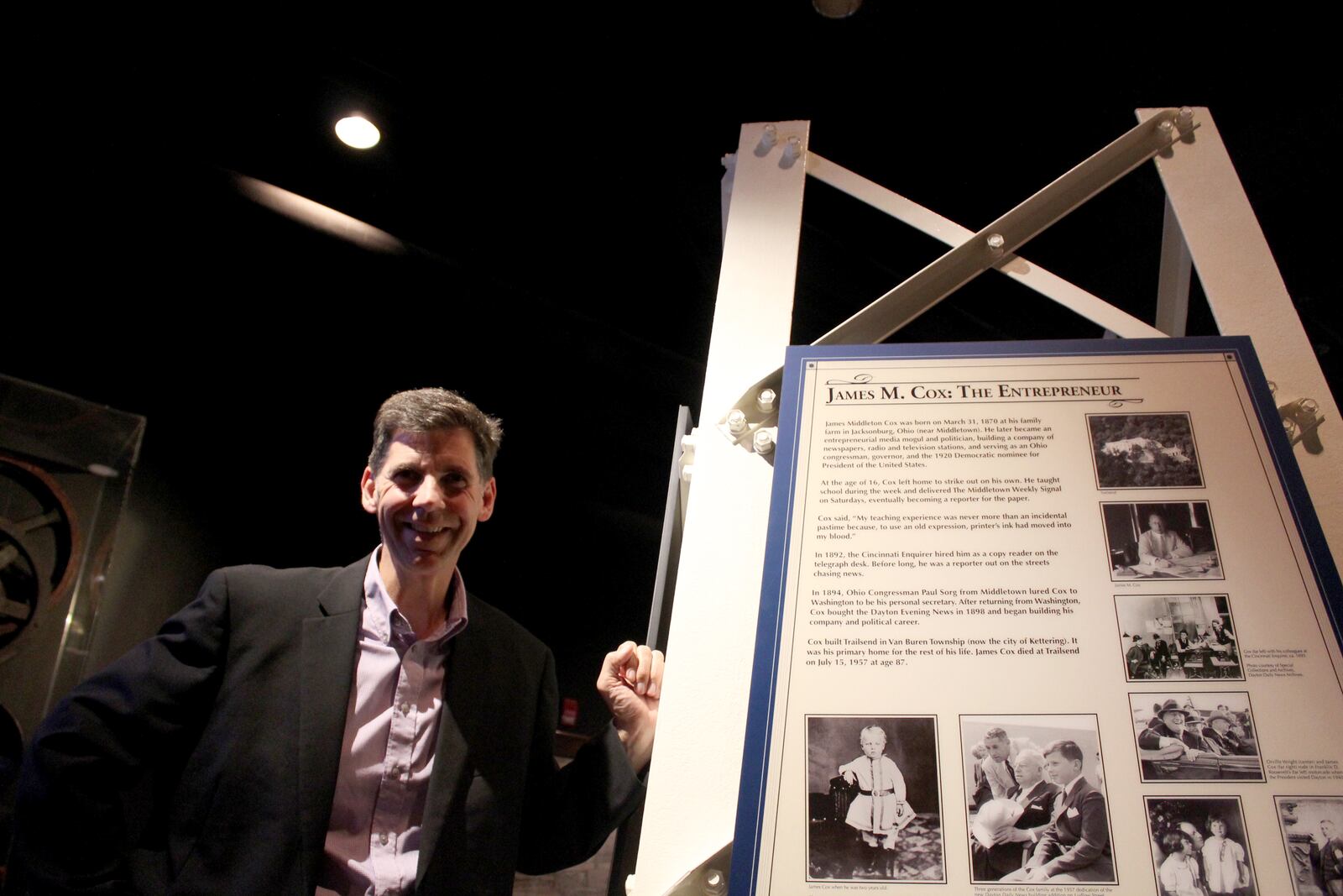 Brady Kress Dayton History,  president & CEO, next to a piece of the WHIO tower dedicated in 1949.