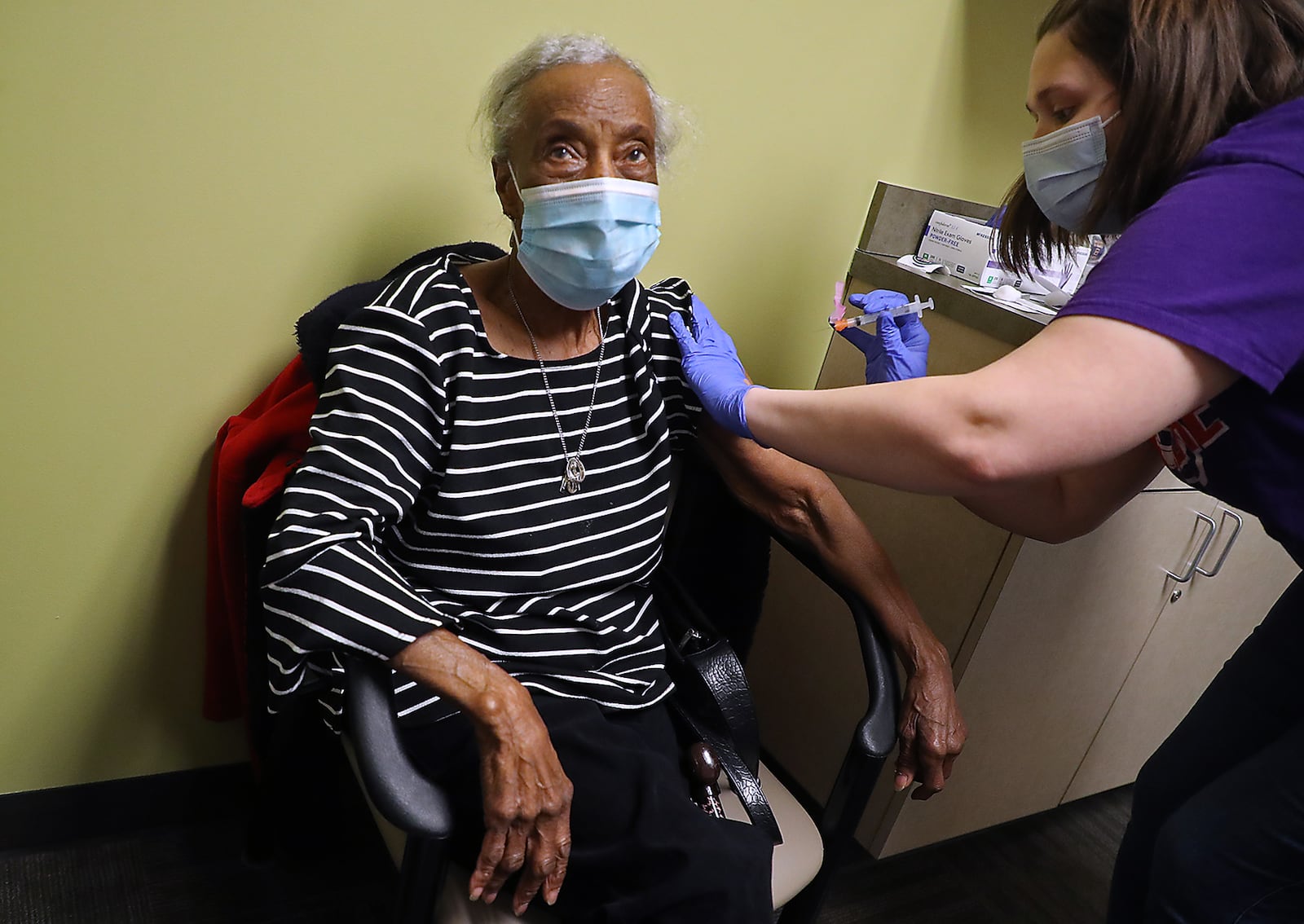 At 98-years-old, Hazel Carter is the oldest person to have gotten the COVID vaccine at the Rocking Horse Center. Hazel got the vaccine on Friday from nurse Tiffany Harris and said she wanted to be a good example for her six children, 25 grandchildren and many great grandchildren by getting the vaccine. BILL LACKEY/STAFF