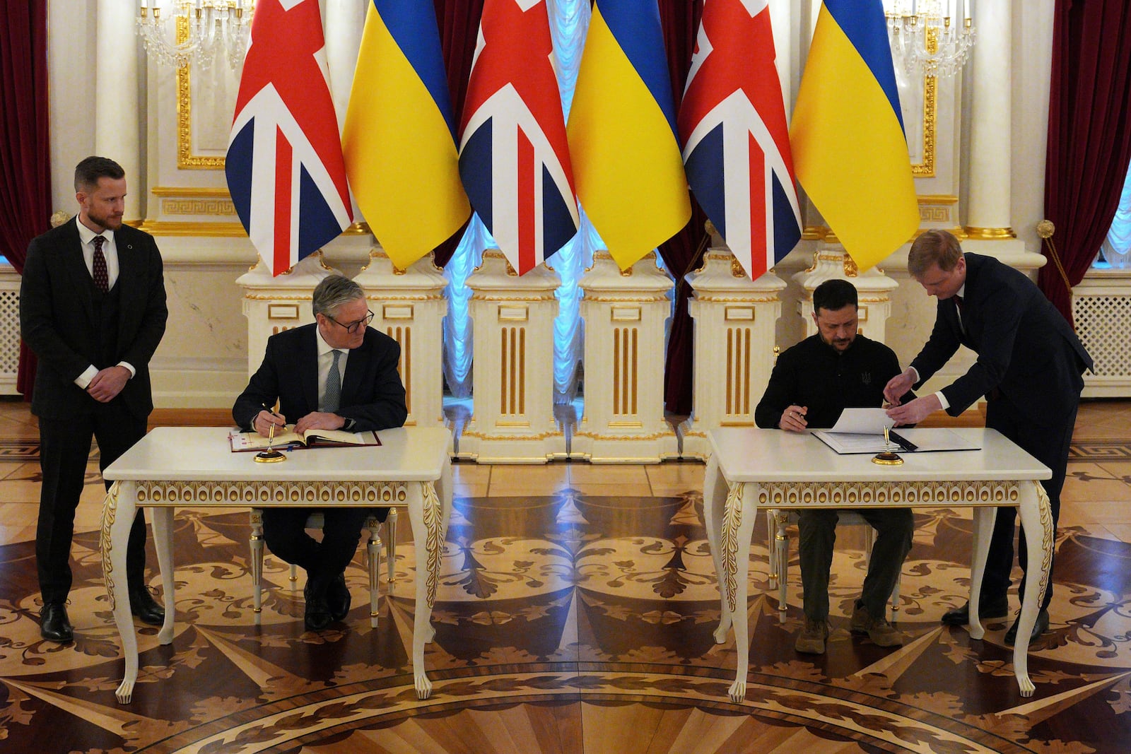 British Prime Minister Keir Starmer, left and Ukrainian President Volodymyr Zelenskyy hold a signing ceremony to commemorate a 100-year partnership between the countries at Mariinskyi Palace, in Kyiv, Ukraine Thursday, Jan. 16, 2025. (Carl Court/Pool Photo via AP)