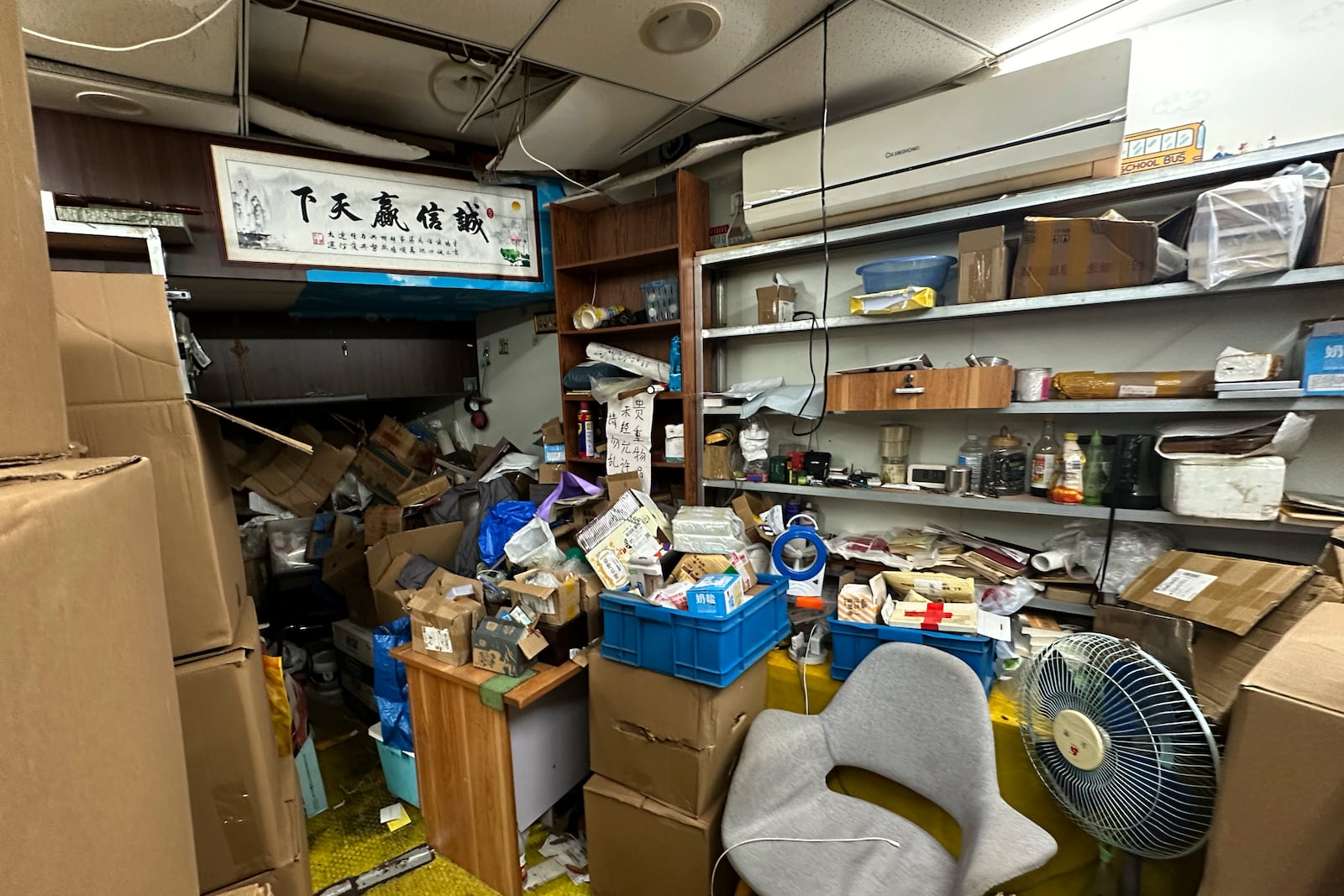 Piles of boxes with books and other belongings are seen inside the shuttered secondhand bookstore "Wang Pangzi" in Ningbo, in eastern China's Zhejiang province, Oct. 9, 2024. (AP Photo/Dake Kang)