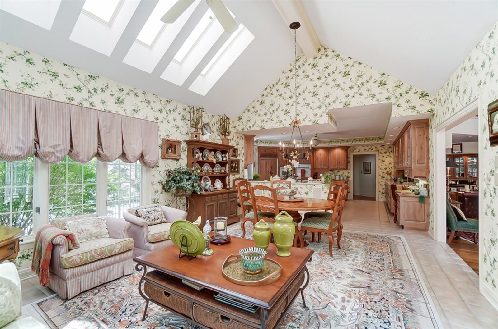 A cathedral ceiling above the breakfast and morning room has seven skylights and a Palladian window. French doors open out from the morning room to the backyard.