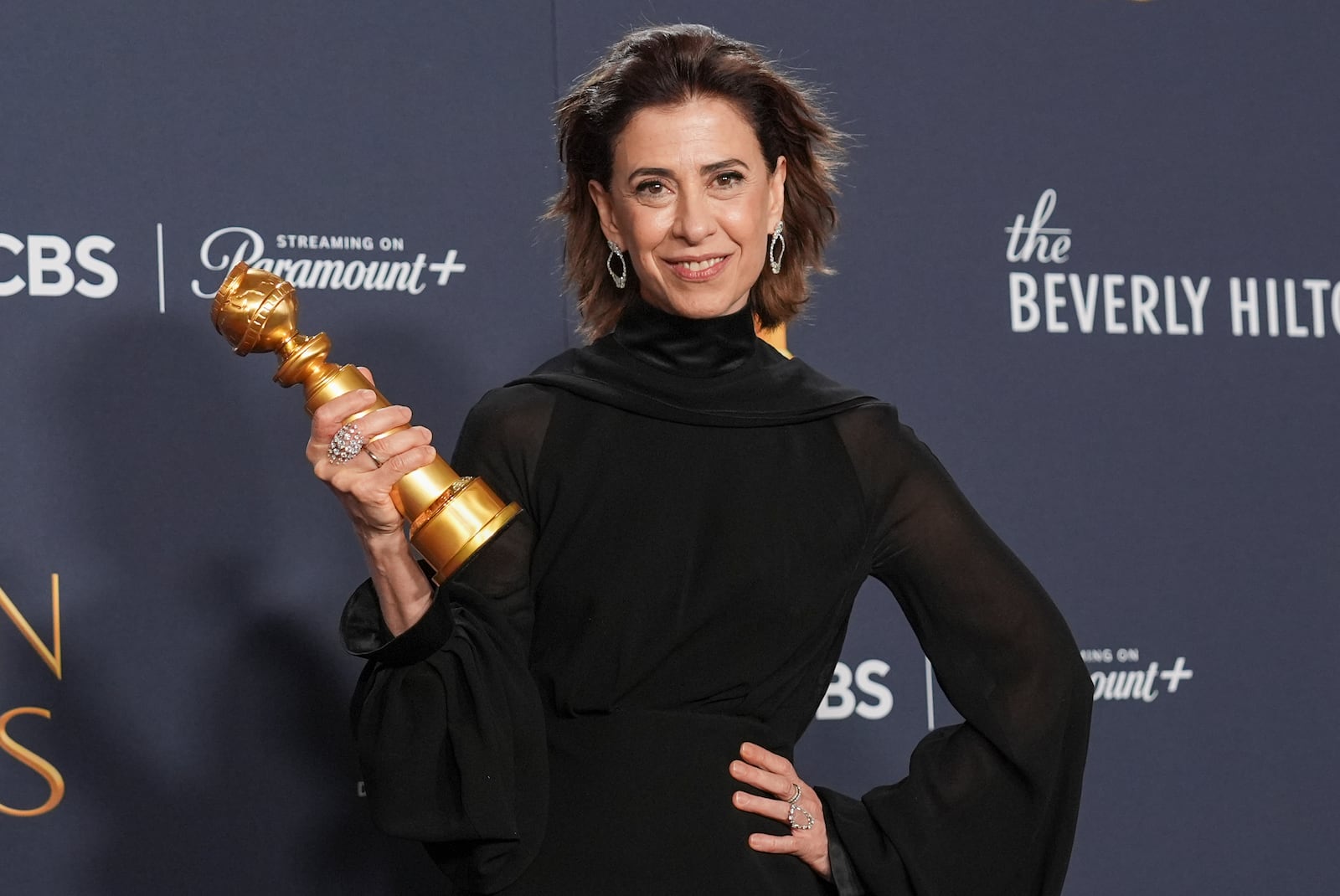 Fernanda Torres poses in the press room with the award for best performance by a female actor in a motion picture - drama for "I'm Still Here" during the 82nd Golden Globes on Sunday, Jan. 5, 2025, at the Beverly Hilton in Beverly Hills, Calif. (AP Photo/Chris Pizzello)