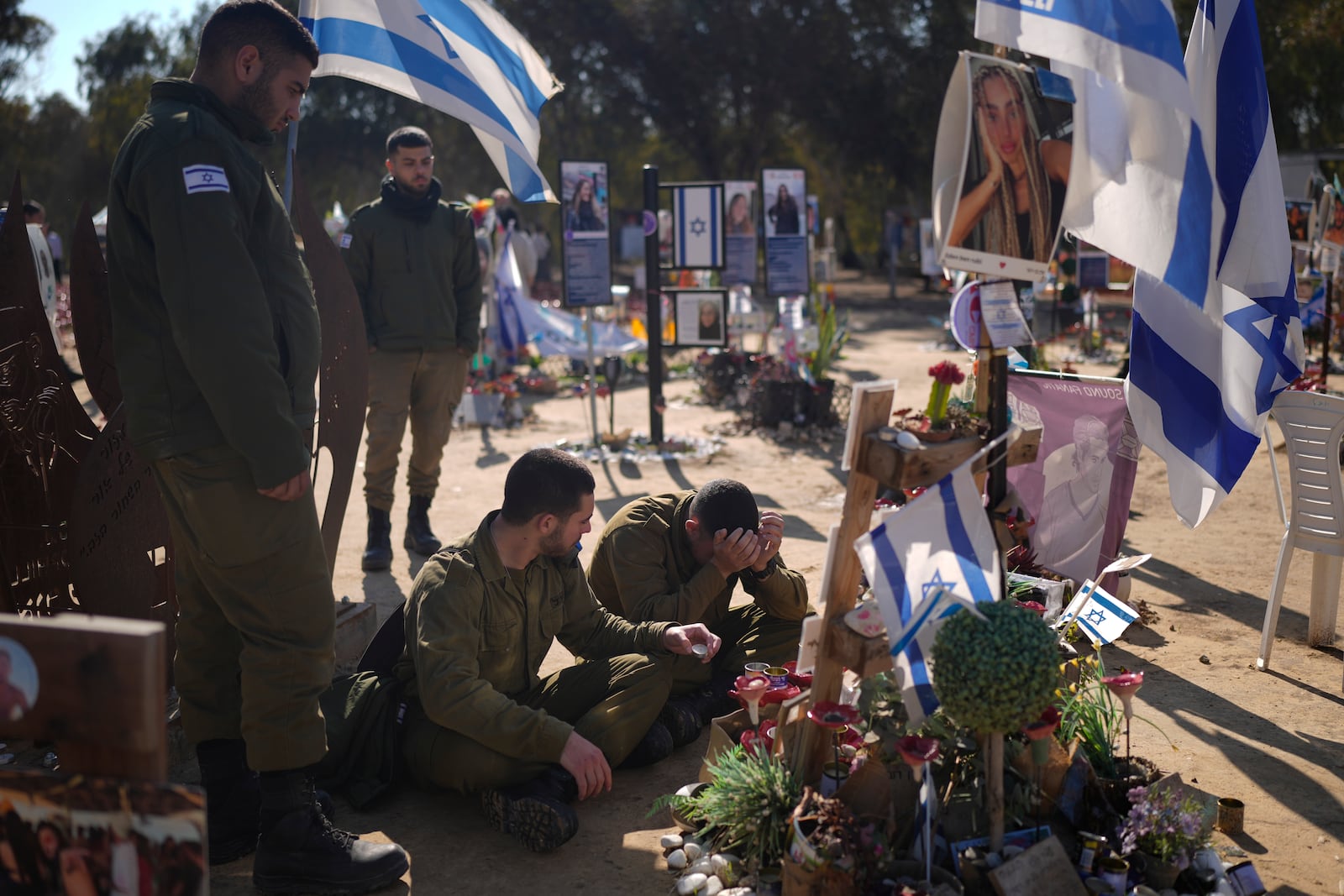 An Israeli soldier weeps in front of a memorial at the site of the Nova music festival, where hundreds of revelers were killed or kidnapped by Hamas, near Kibbutz Re'im in southern Israel, close to the Gaza Strip, Thursday, Jan. 2, 2025. (AP Photo/Matias Delacroix)