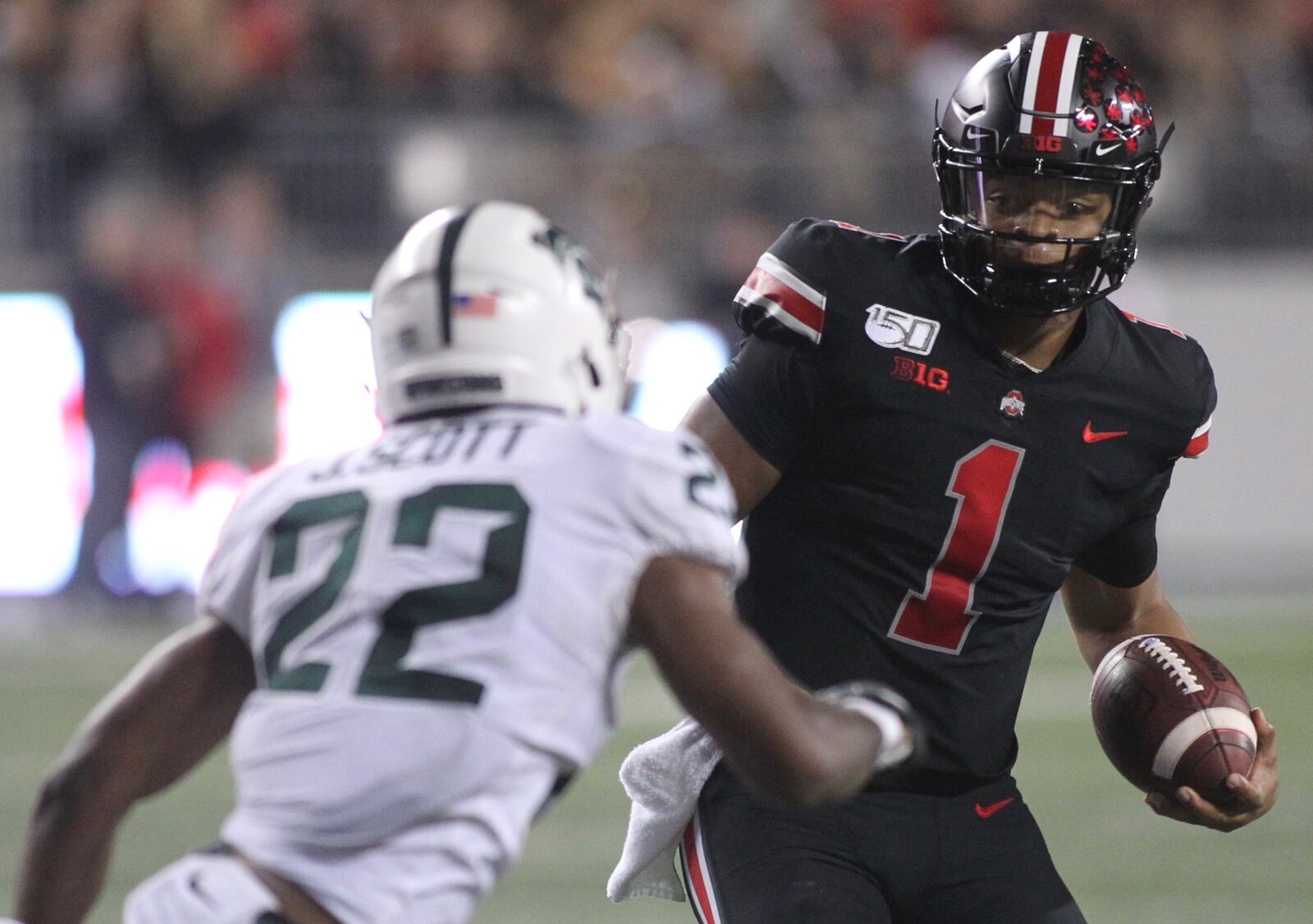 Ohio State's Justin Fields is pursued by Michigan State's Josiah Scott on Saturday, Oct. 5, 2019, at Ohio Stadium in Columbus. David Jablonski/Staff