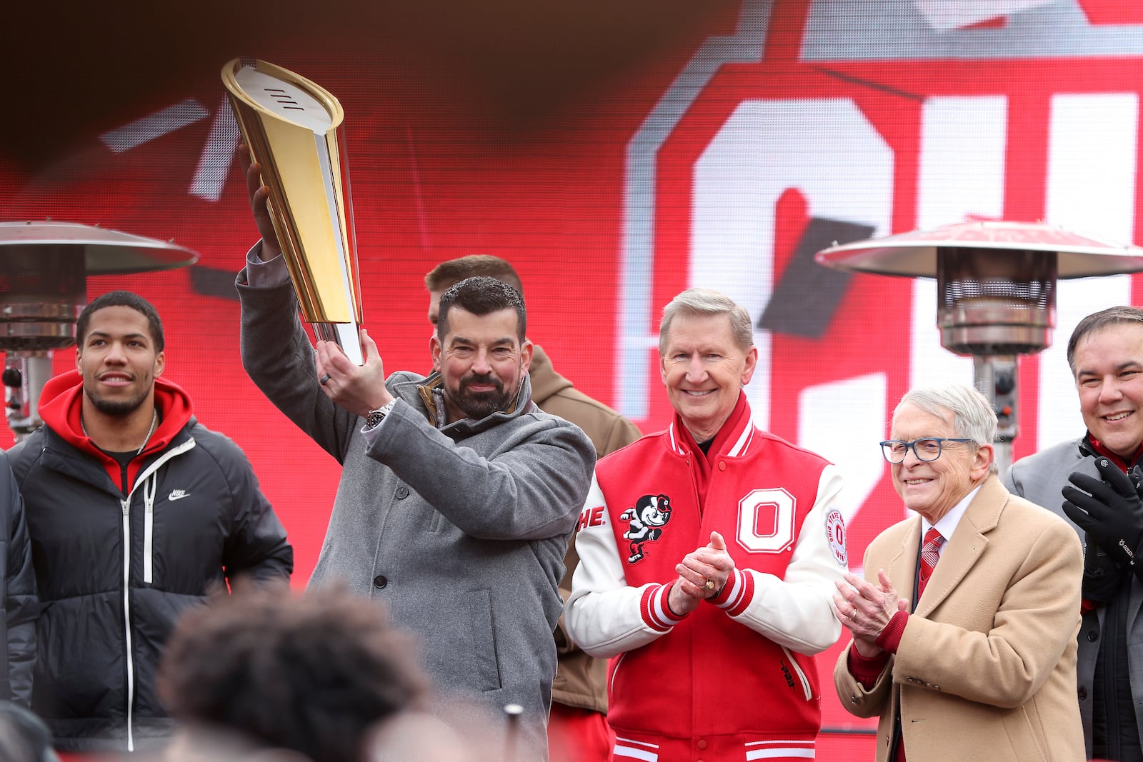 Ohio State Buckeyes head coach Ryan Day (from left) poses with Ohio State University president Ted Carter (center), Ohio Governor Mike DeWine, and Columbus Mayor Andrew Ginther during the National Championship football celebration at Ohio Stadium in Columbus, Ohio, Sunday, Jan. 26, 2025. (AP Photo/Joe Maiorana)