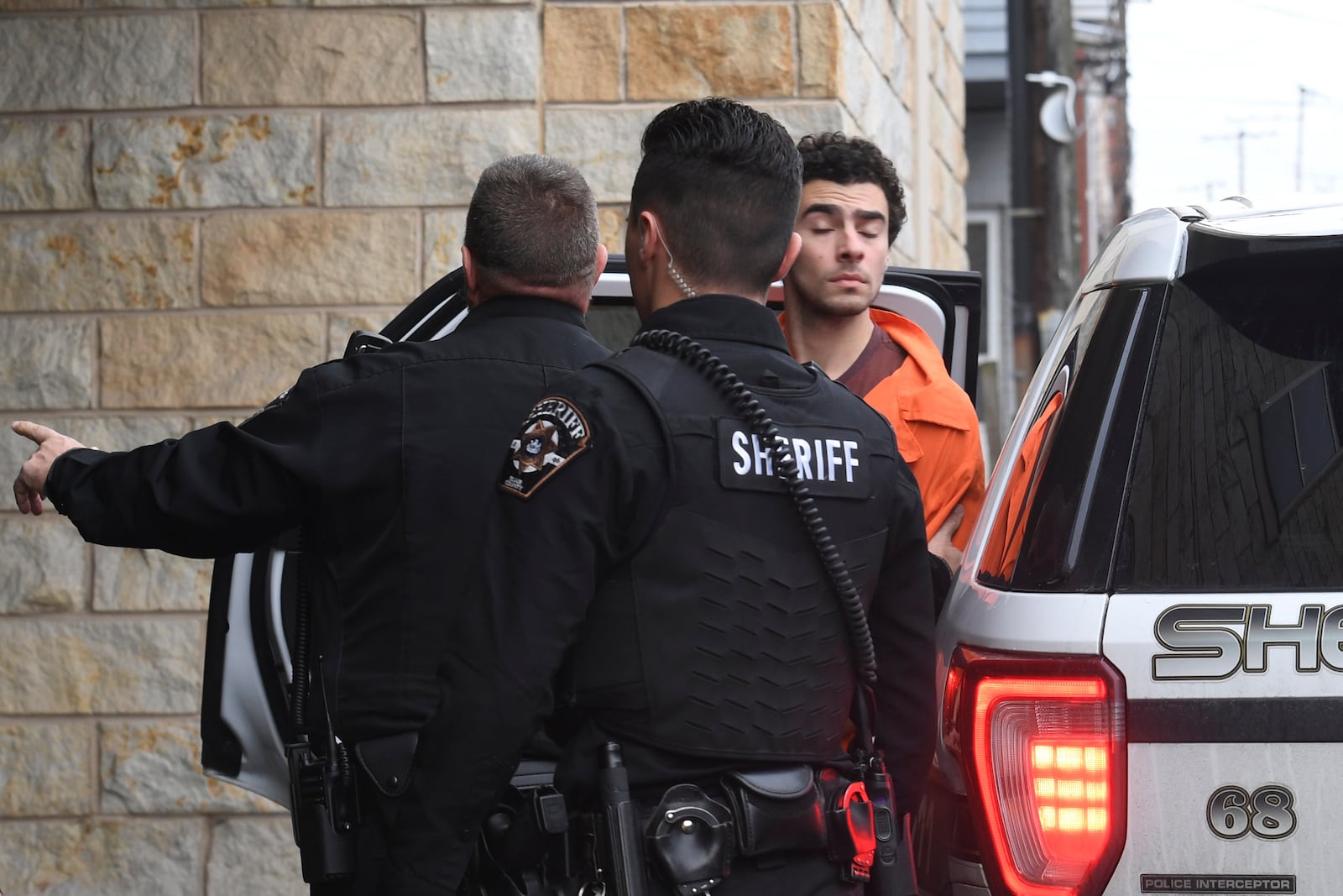 Luigi Nicholas Mangione is escorted into Blair County Courthouse, Tuesday, Dec. 10, 2024, in Hollidaysburg, Pa. (AP Photo/Gary M. Baranec)