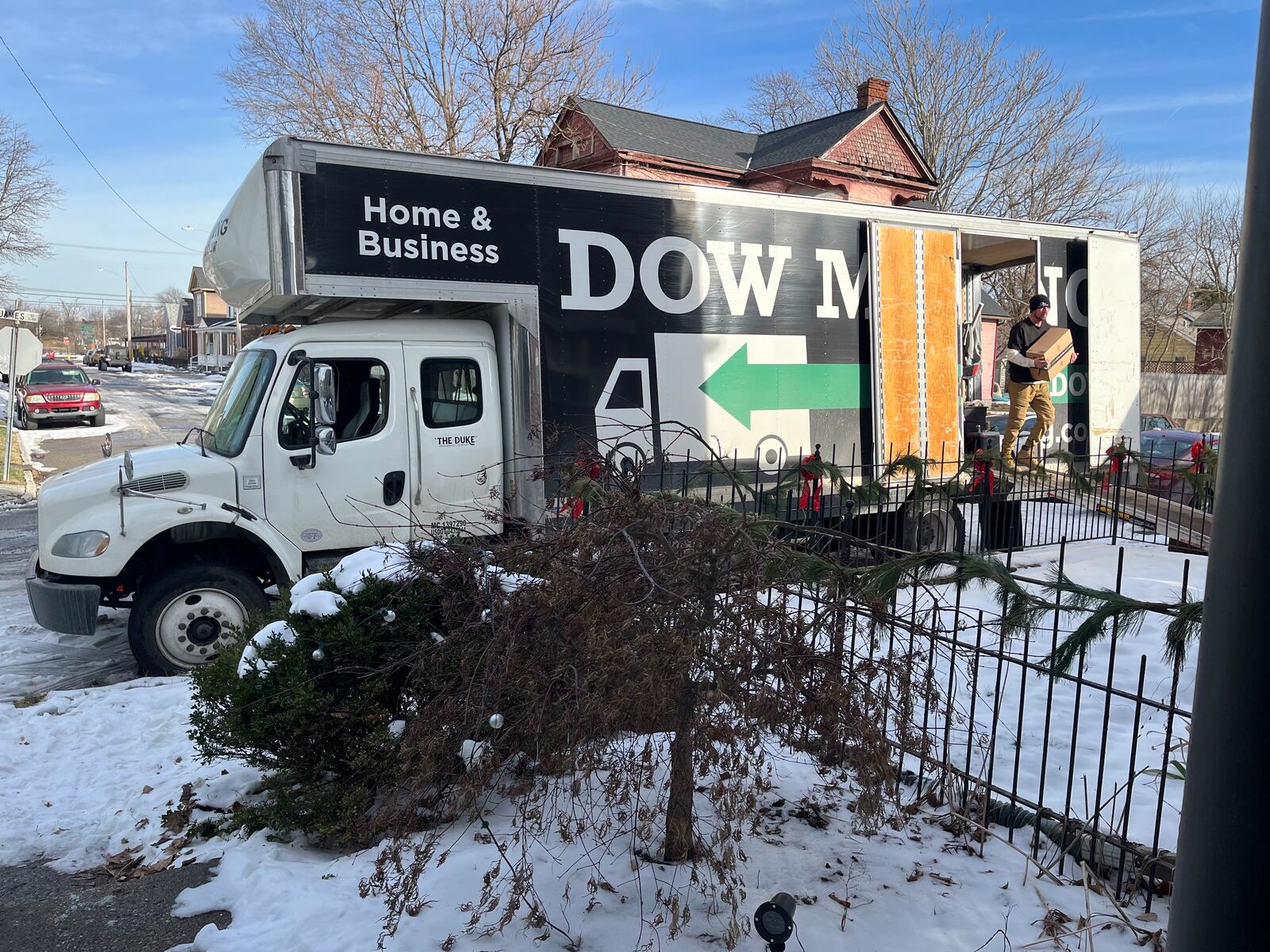 Employees with a moving company carry boxed items into a home in the South Park neighborhood in Dayton. CORNELIUS FROLIK / STAFF