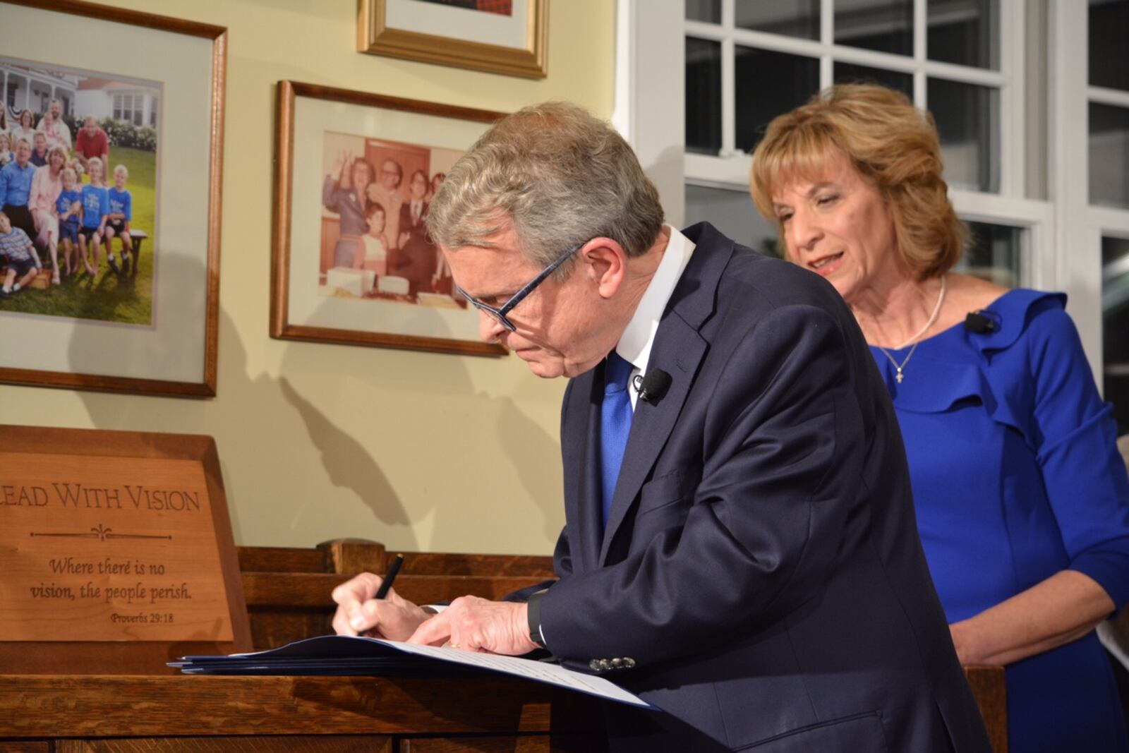 Gov. Mike DeWine signs executive orders after taking oath as governor. Photo by Jim Otte, WHIO TV