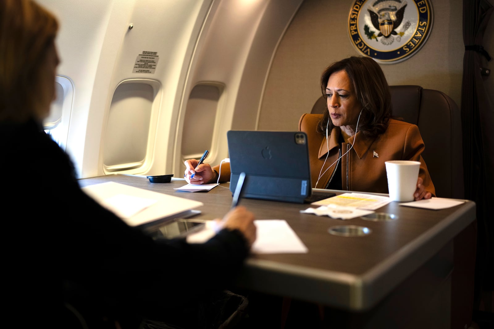 Democratic presidential nominee Vice President Kamala Harris works aboard Air Force Two while on a call en route from Texas to Michigan, Saturday, Oct. 26, 2024. (Erin Schaff/The New York Times via AP, Pool)