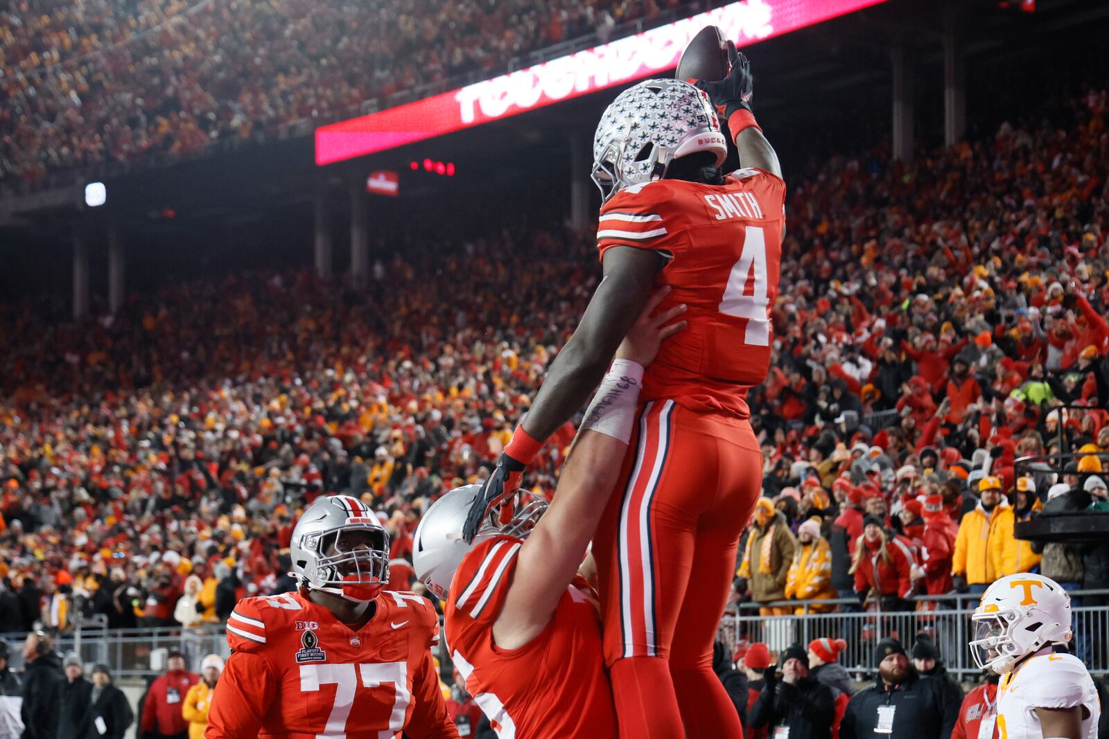 Ohio State receiver Jeremiah Smith, top, celebrates after his touchdown against Tennessee during the second half in the first round of the College Football Playoff, Saturday, Dec. 21, 2024, in Columbus, Ohio. (AP Photo/Jay LaPrete)