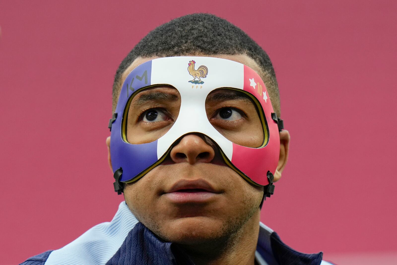 FILE - France's Kylian Mbappe looks up as he wears a face mask during a team training session in Leipzig, Germany, Thursday, June 20, 2024. (AP Photo/Hassan Ammar, file)