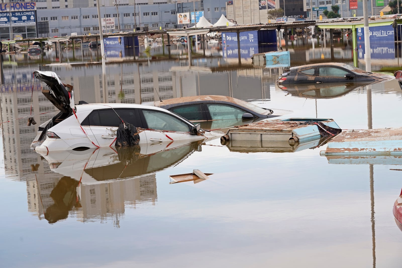 Cars are seen half submerged after floods in Valencia, Spain, Friday, Nov. 1, 2024. (AP Photo/Alberto Saiz)