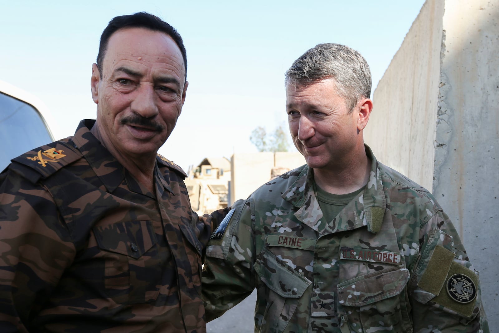 This image provided the U.S. Army shows, Air Force Brig. Gen. Daniel Caine, right, meeting with Ninewa Operational Center Commander, Major Gen. Najim, in Mosul, Iraq, June 26, 2018. (SPC Keisha Brown/U.S. Army via AP)