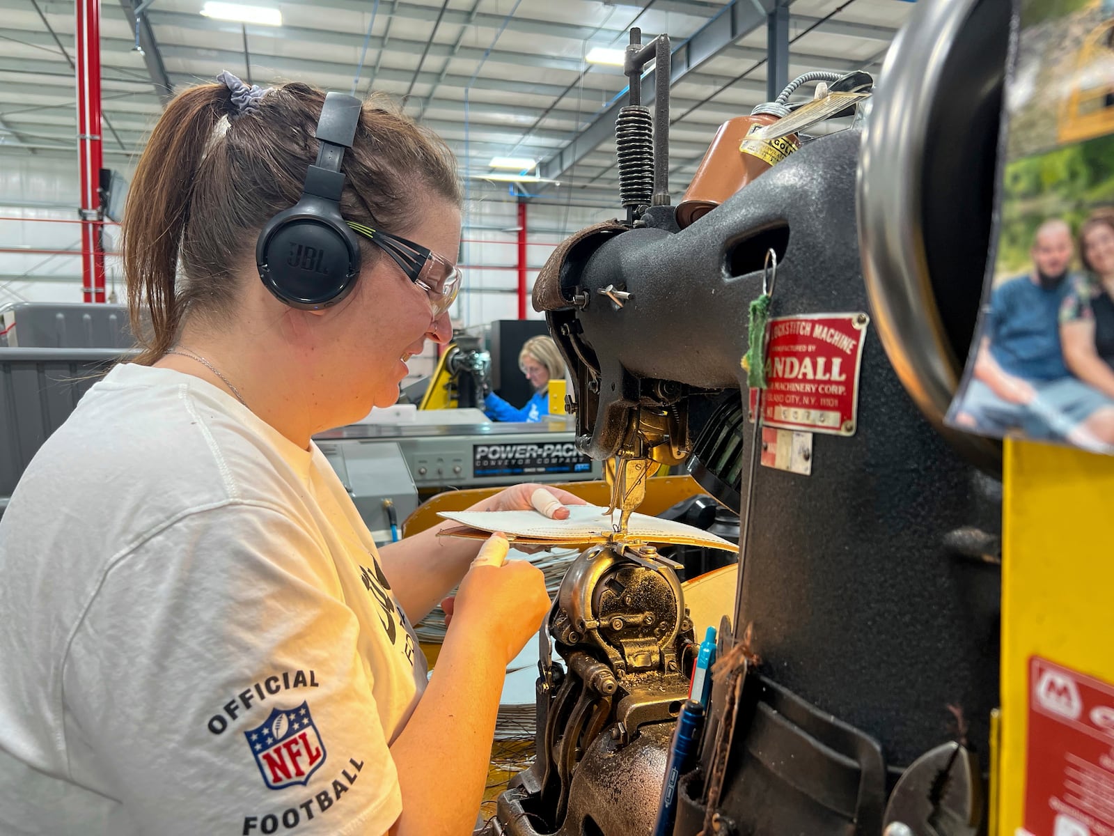 Wilson Sporting Goods football factory employee CJ Dyer makes a football for the upcoming Super Bowl matchup between the Philadelphia Eagles and the Kansas City Chiefs by using a machine that stitches the ball, Monday, January 27, 2025, in Ada, Ohio.(AP Photo/Patrick Aftoora-Orsagos)