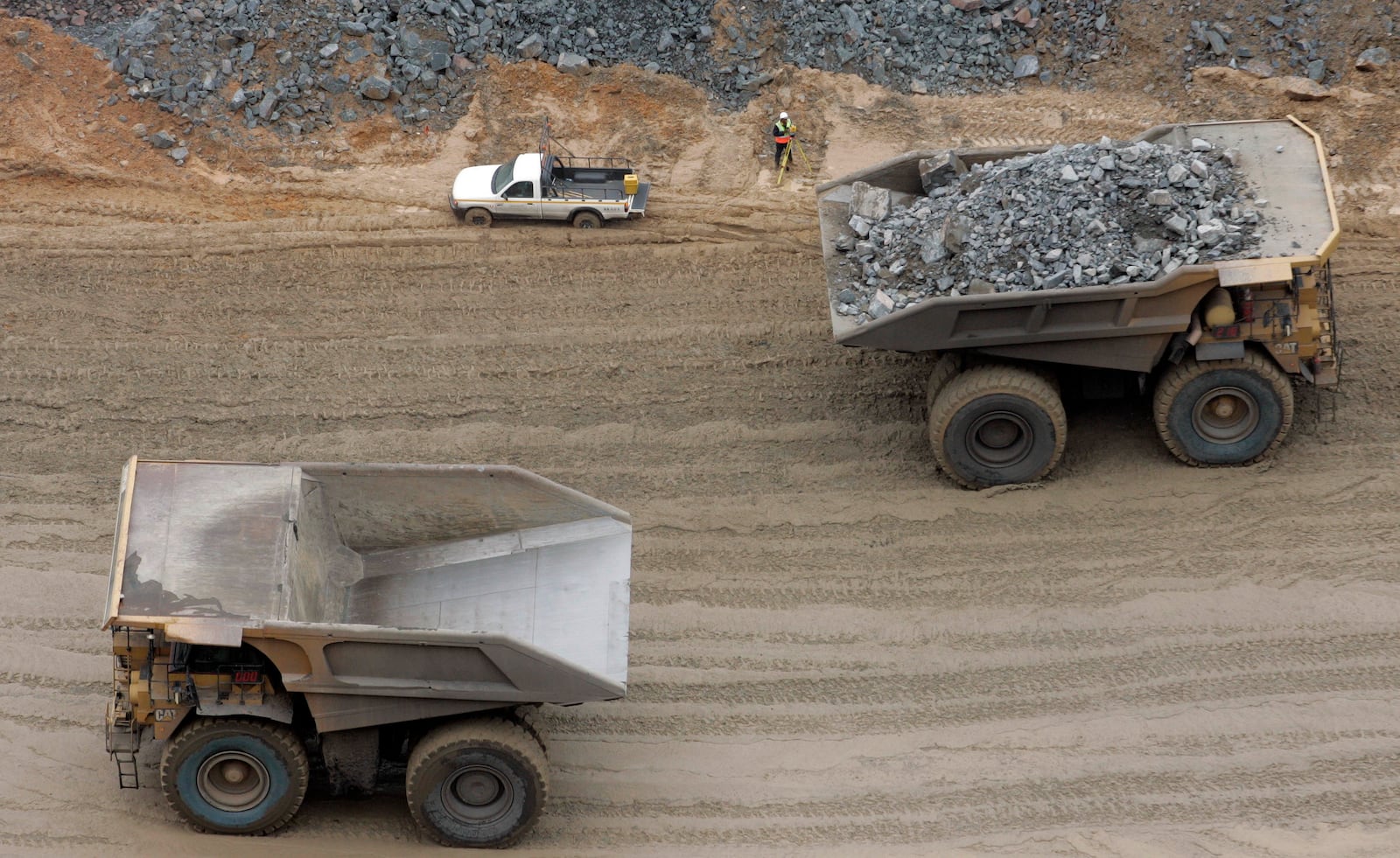 FILE -Mine trucks are seen in the open pit at a Debswana mine, a joint venture between De Beers and Botswana's government, in Jwaneng, Botswana, Monday March 17, 2008. (AP Photo/Themba Hadebe, File)