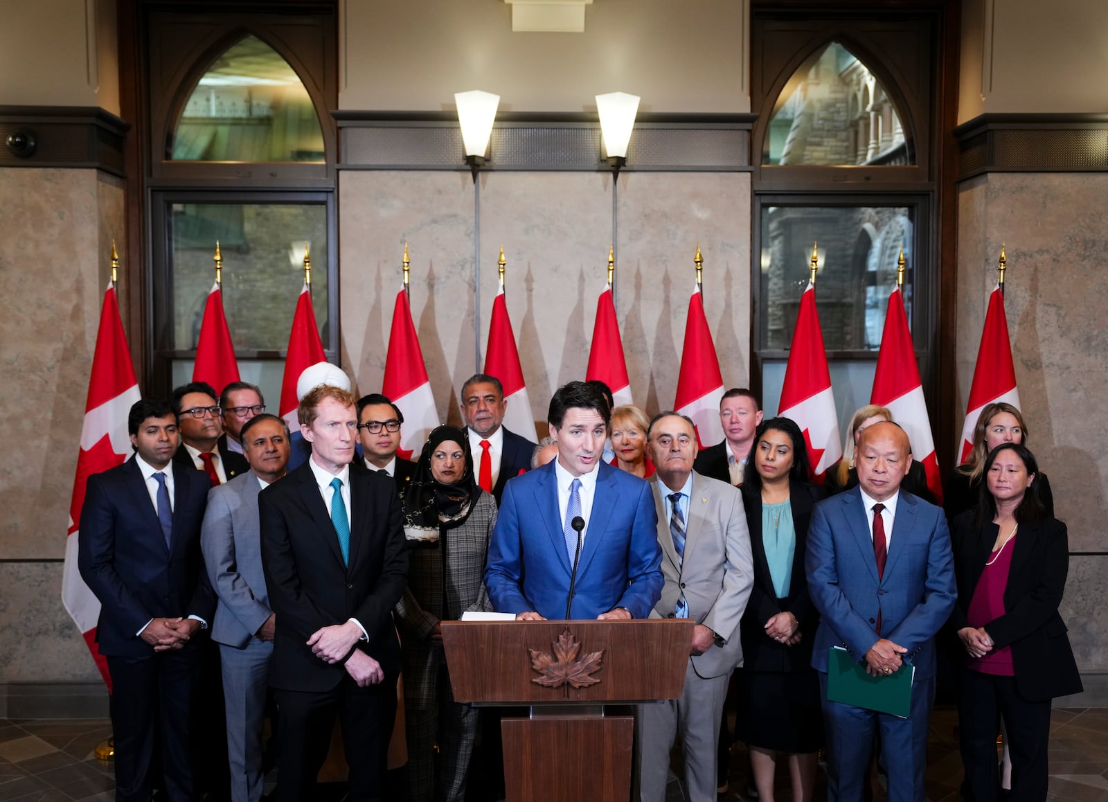 Prime Minister Justin Trudeau and Immigration, Refugees and Citizenship Minister Marc Miller are joined by fellow members of Parliament as they hold a press conference on Parliament Hill in Ottawa Thursday, Oct. 24, 2024. (Sean Kilpatrick/The Canadian Press via AP)