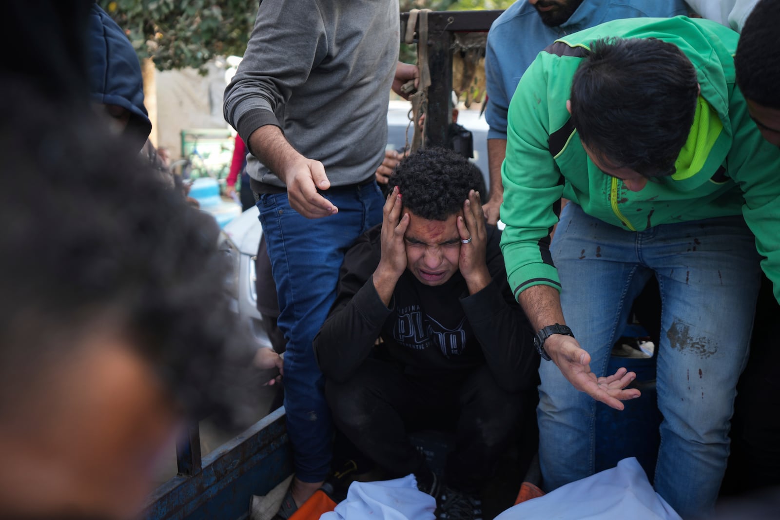 Palestinians mourn their relatives killed in the Israeli bombardment of Maghazi in the Gaza Strip, during their funeral at a hospital morgue in Deir al-Balah, Gaza, Thursday, Nov. 14, 2024. (AP Photo/Abdel Kareem Hana)