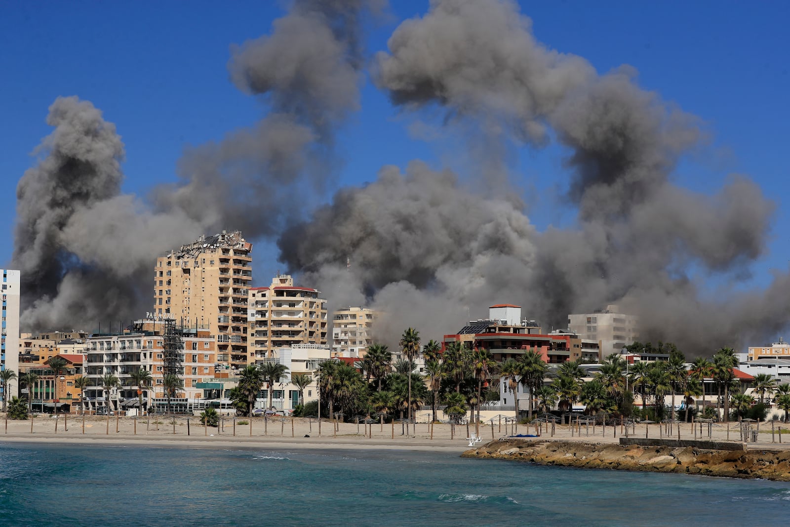 Smoke rises from buildings hit in Israeli airstrikes in Tyre, Lebanon, Wednesday, Oct. 23, 2024. (AP Photo/Mohammad Zaatari)