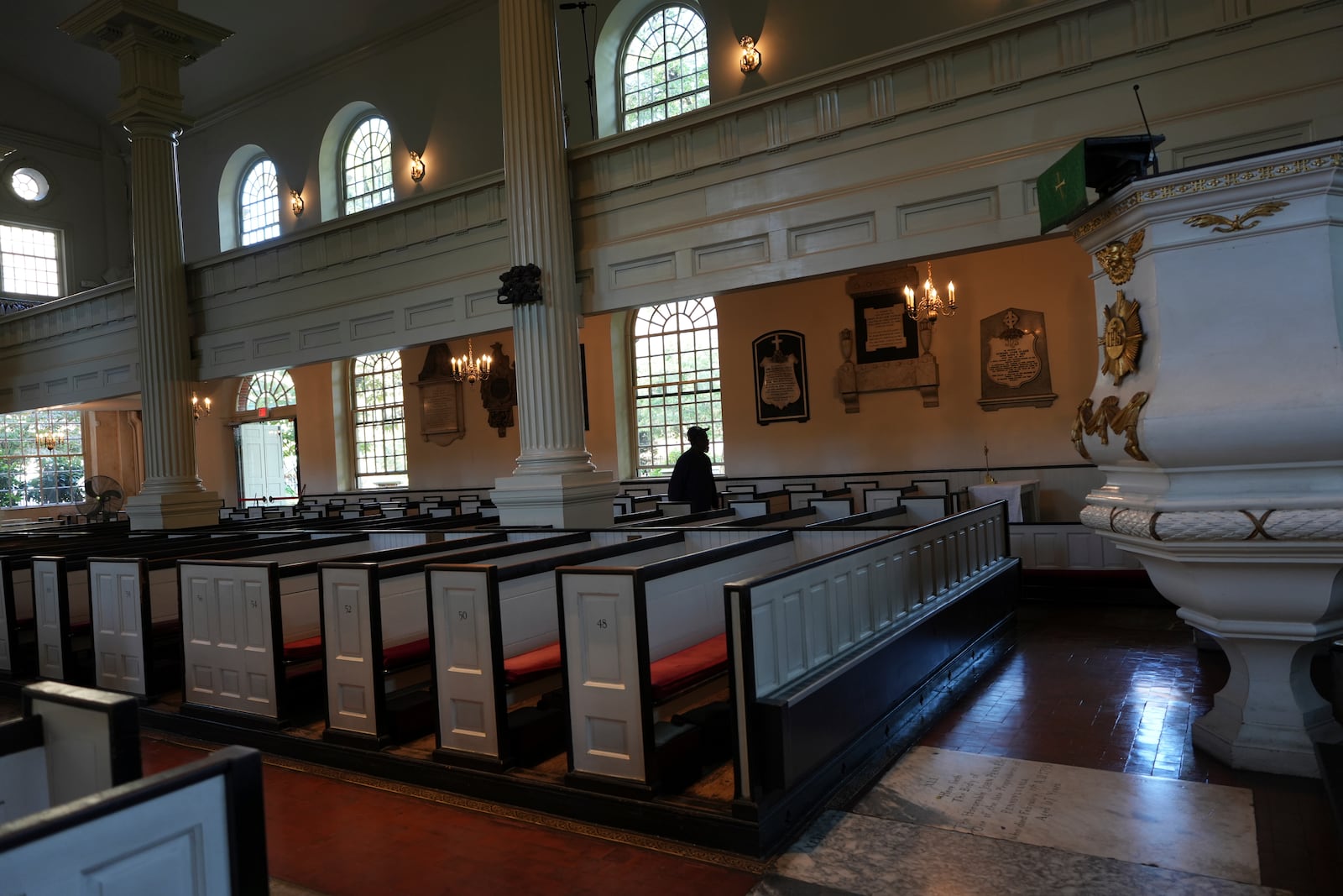 A Christ Church employee walks around the "Nation’s Church" after opening it for service in Philadelphia on Sunday, Oct. 6, 2024. (AP Photo/Luis Andres Henao)