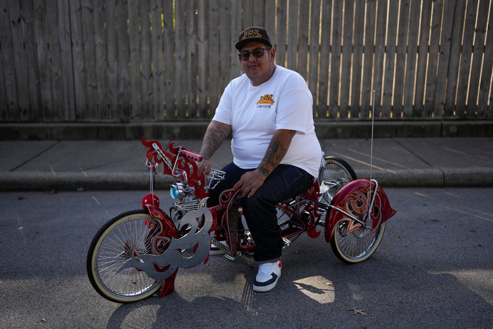 Luis Martinez, 29, a member of the Uso Chicago Car Club, sits on his custom-built lowrider bike Saturday, Sept. 21, 2024, in Mishawaka, Ind. (AP Photo/Erin Hooley)