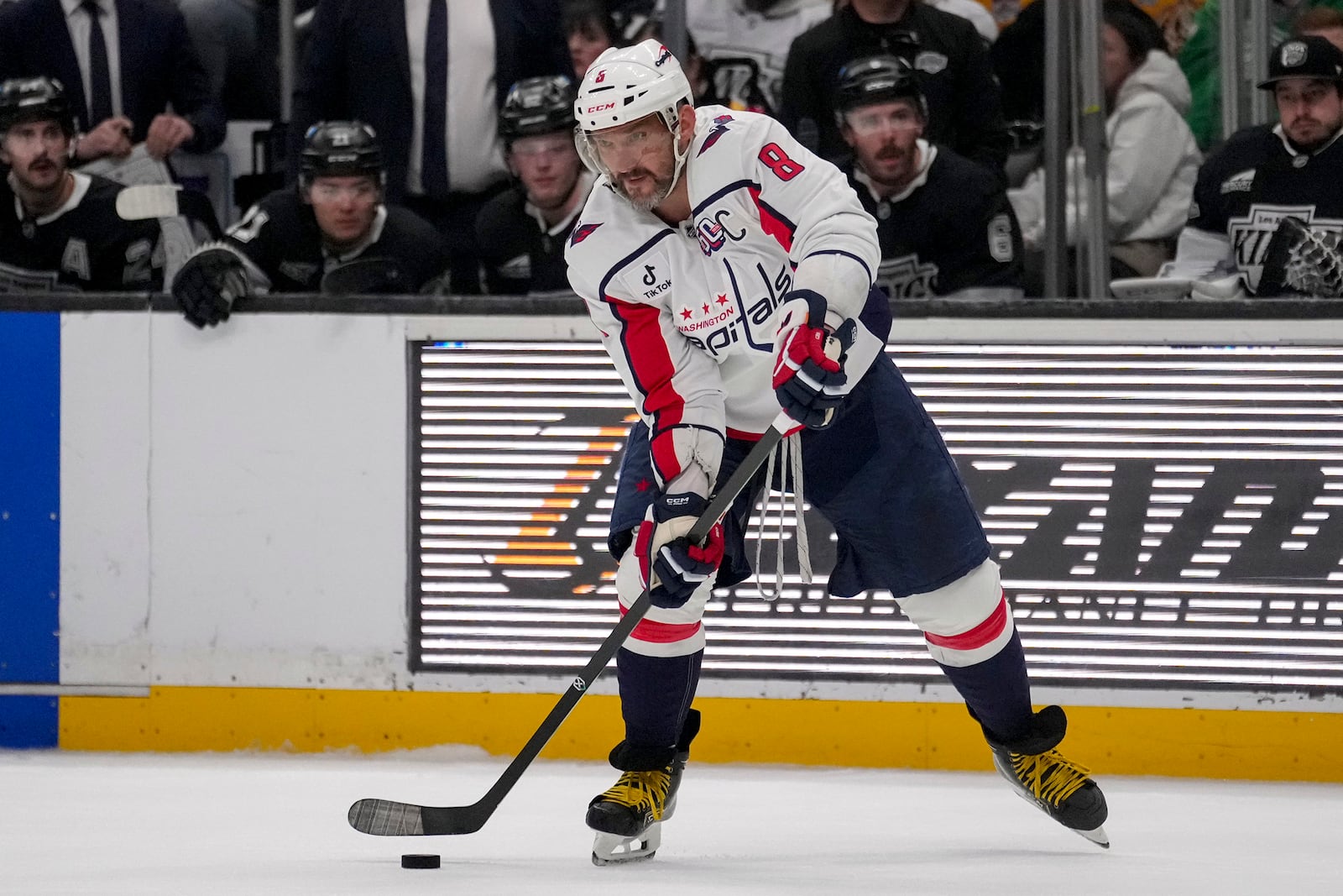 Washington Capitals left wing Alex Ovechkin (8) passes the puck during the third period of an NHL hockey game against the Los Angeles Kings Thursday, March 13, 2025, in Los Angeles. (AP Photo/Eric Thayer)