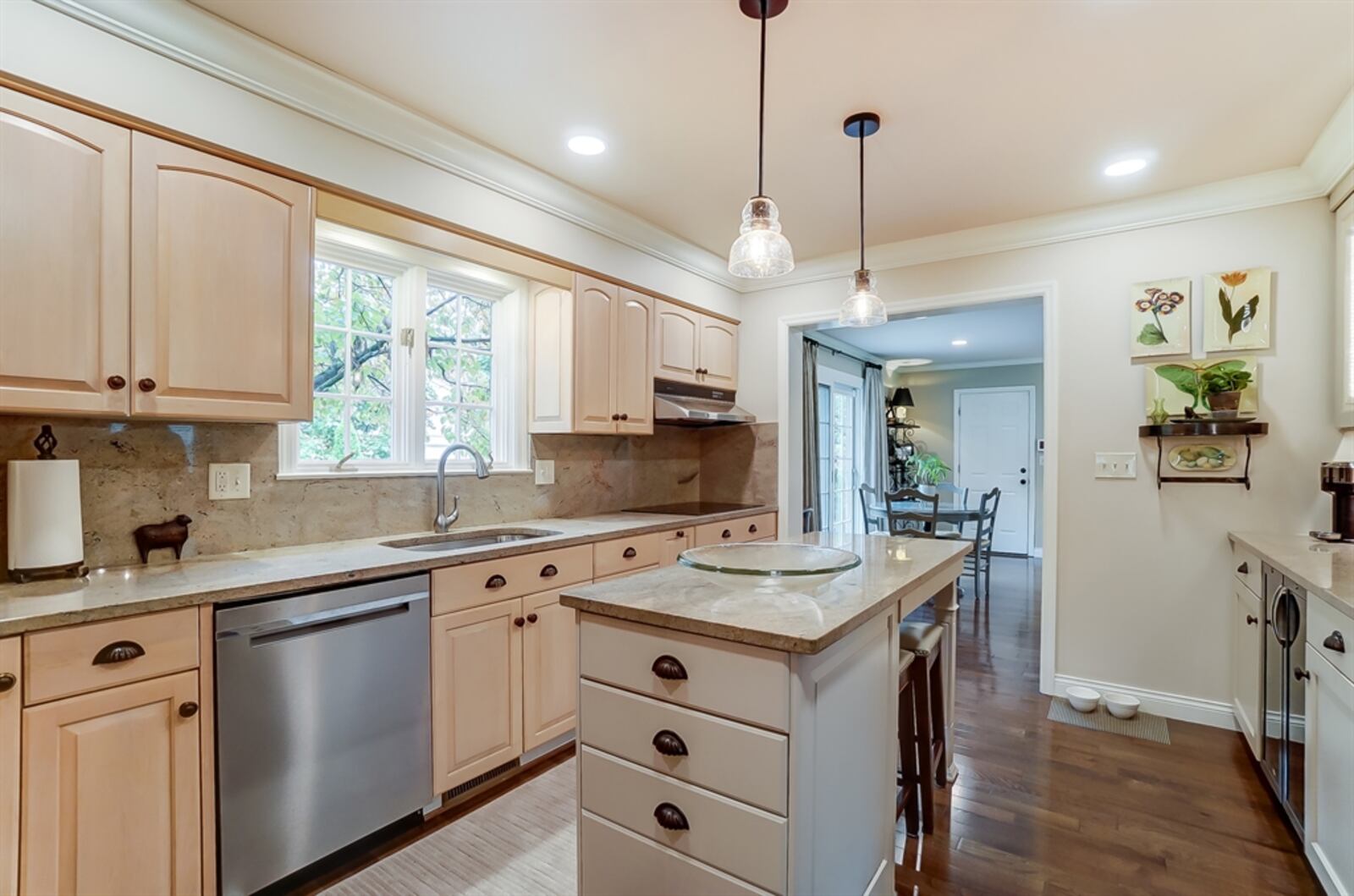 The updated kitchen features double-wall ovens, a buffet bar with bubble-glass cabinet doors and a dual wine and beverage cooler.