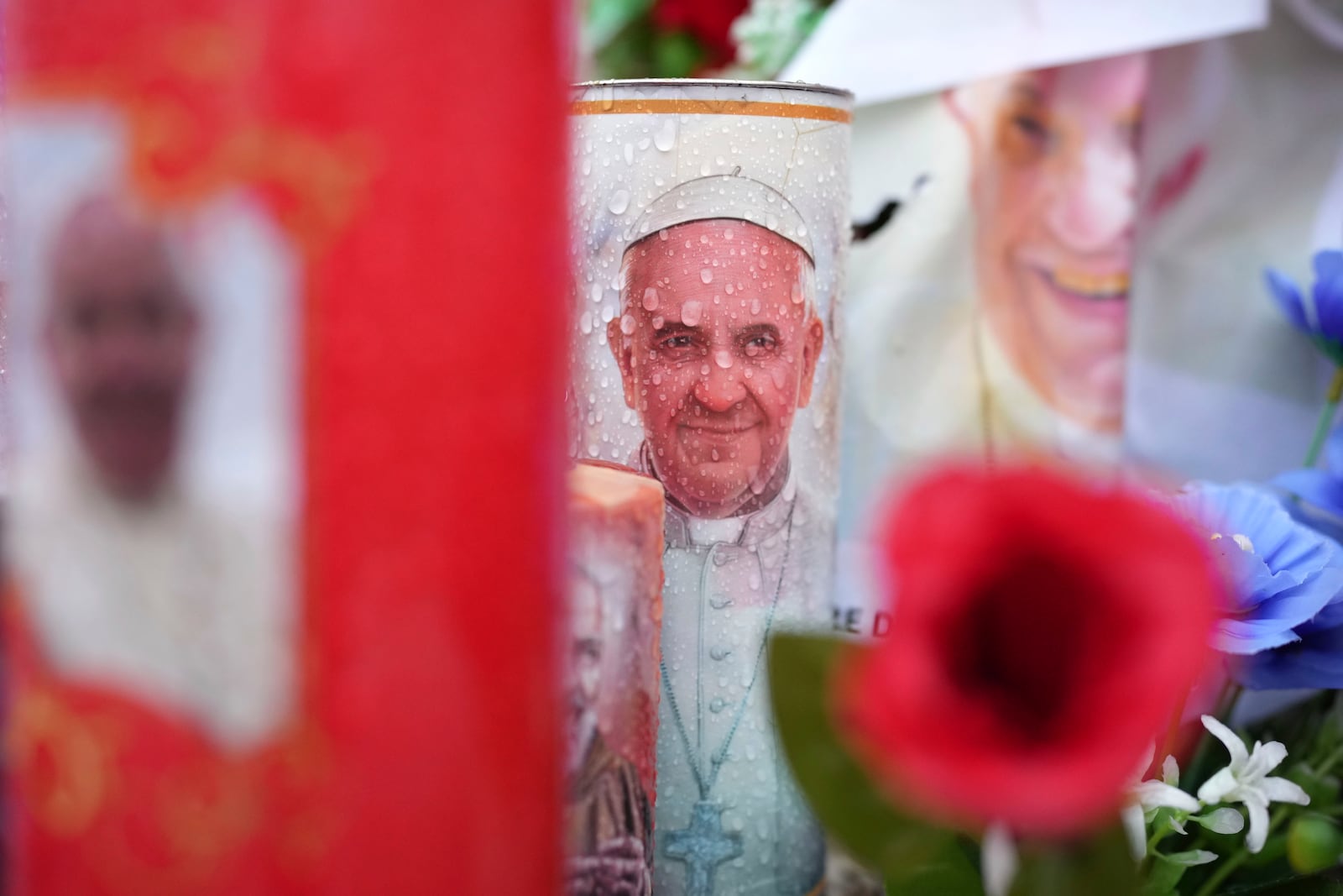 Candles and flowers for Pope Francis are seen at the Agostino Gemelli Polyclinic, in Rome, Tuesday, Feb. 25, 2025 where Pope Francis is hospitalised since Friday, Feb. 14. (AP Photo/Alessandra Tarantino)