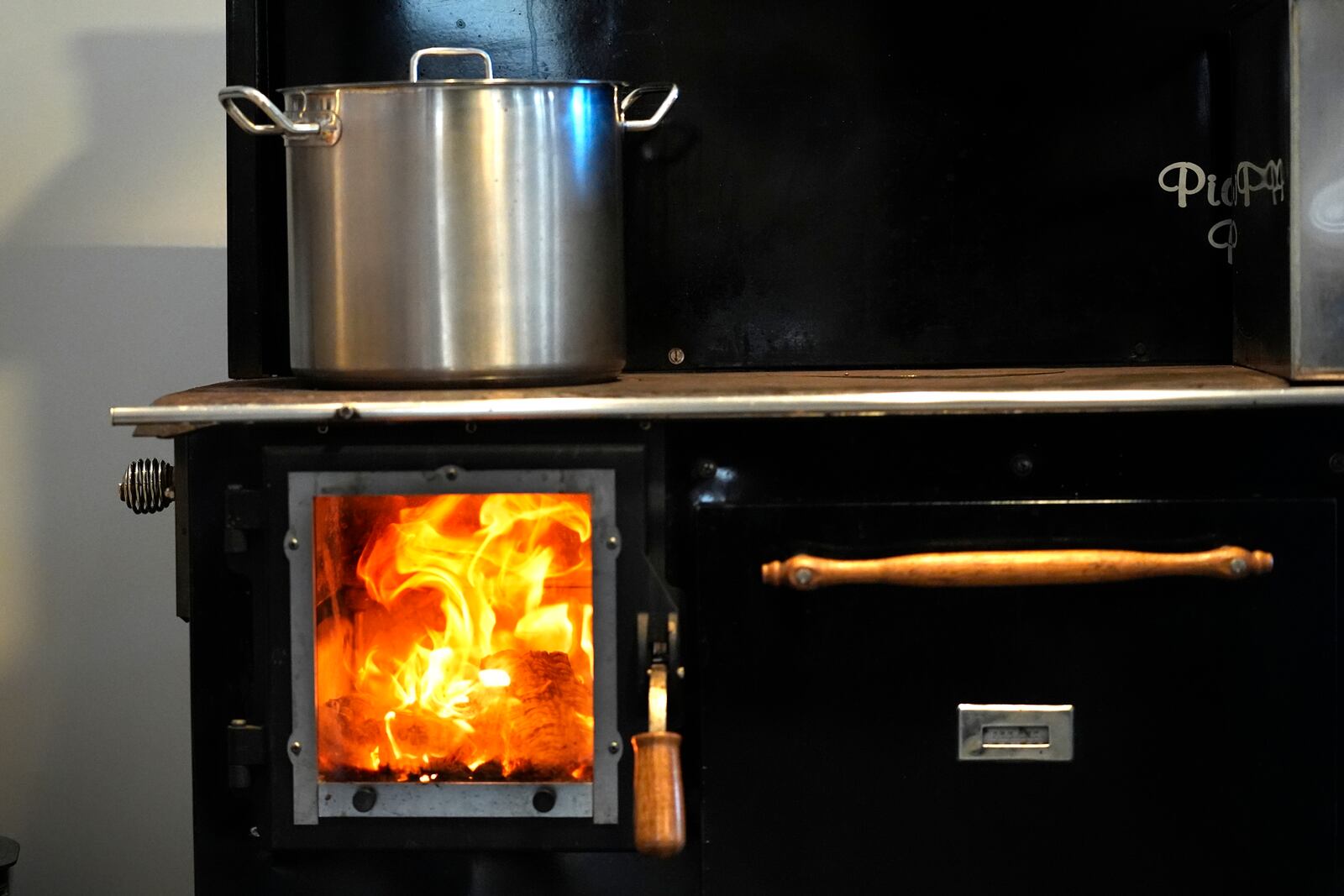 A pot of wild blueberries cooks on a woodstove at Intervale Farm, Monday, Feb. 10, 2025, in Cherryfield, Maine. (AP Photo/Robert F. Bukaty)