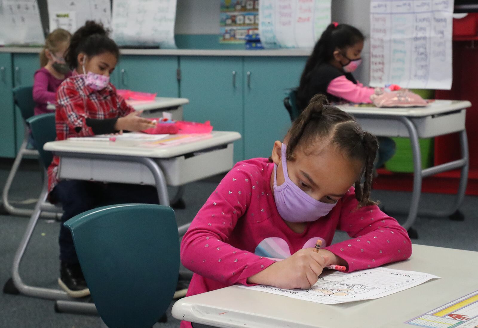 With masks and desks spaced apart, students at Simon Kenton Elementary work on classwork Friday, Feb. 19, 2021. BILL LACKEY/STAFF