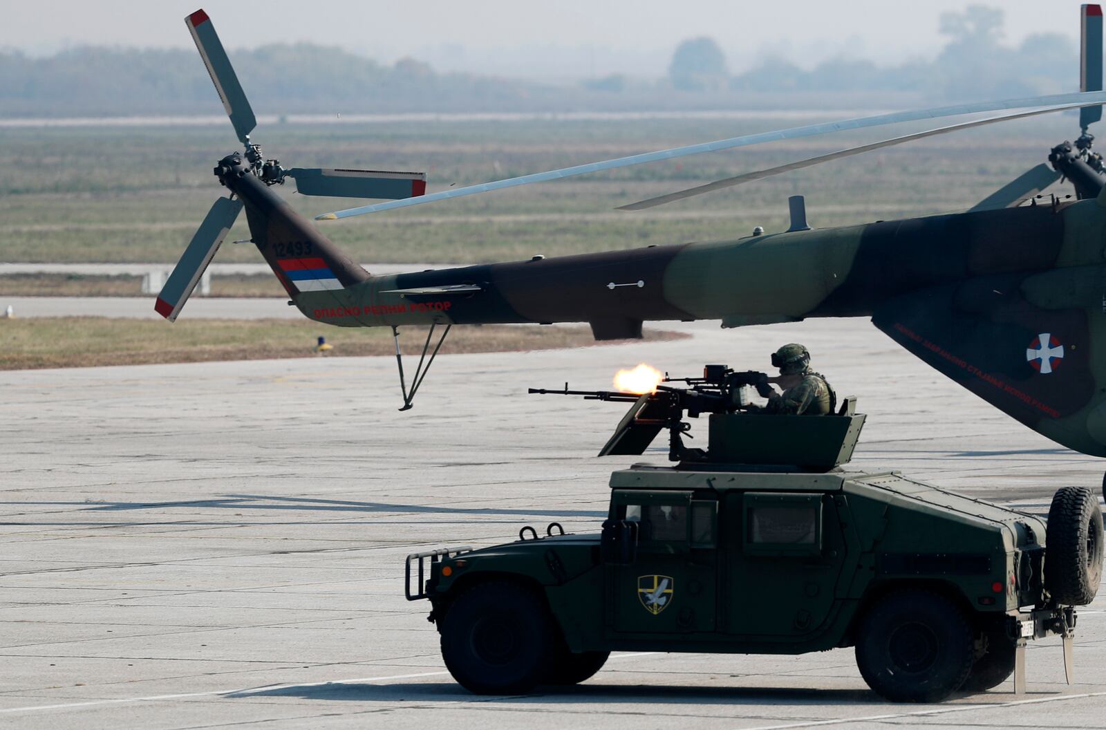 In this photo taken Saturday, Oct. 19, 2019, Serbian Army soldiers perform during a military parade at the military airport Batajnica, near Belgrade, Serbia.  Citing alleged pressure from the West, Serbia has suspended all foreign military exercises Wednesday Sept. 9, 2020, ahead of the planned manoeuvres with Russia and Belarus. (AP Photo/Darko Vojinovic)