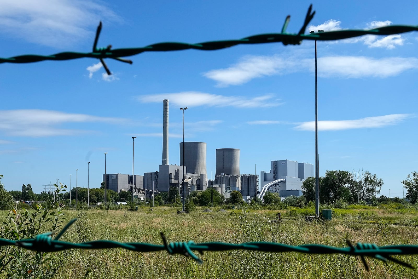 FILE - The shut down coal-fired power plant Westfalen of RWE Generation SE is seen behind a fence in Hamm, Germany, Thursday, Aug. 10, 2023. (AP Photo/Martin Meissner, File)