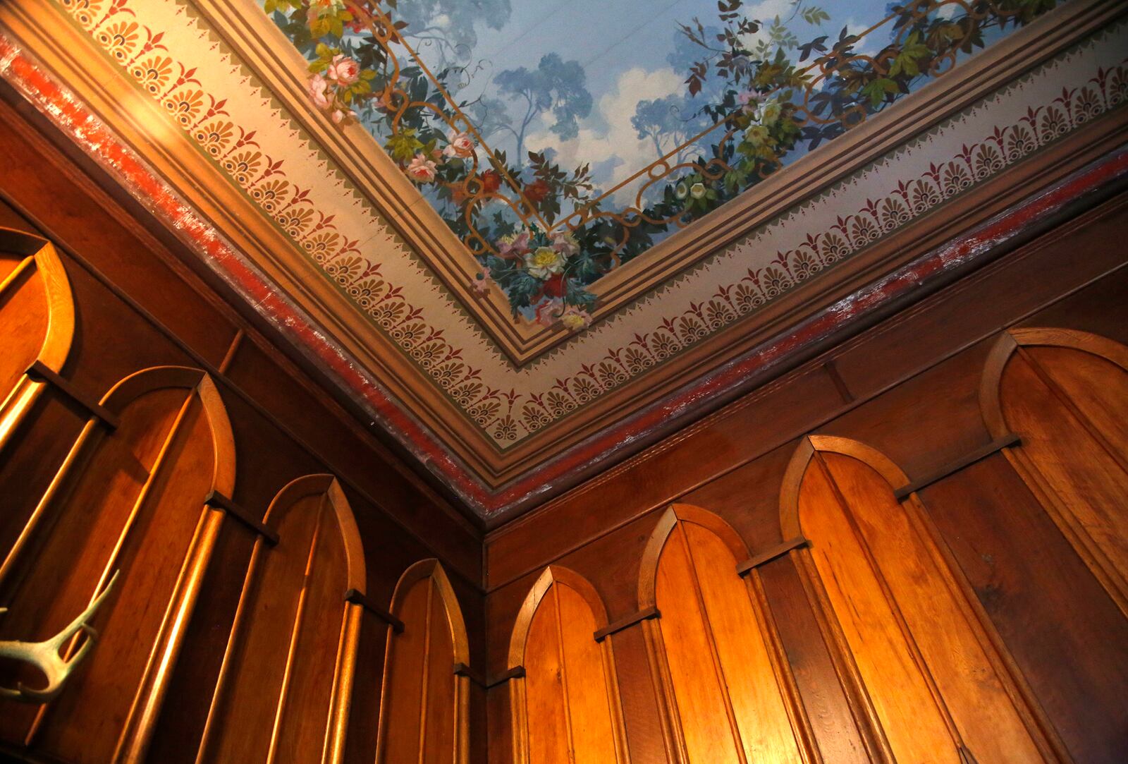 A detail of a fresco painted in 1881 by artist Oliver Frey on the ceiling of the drawing room at Mac-A-Cheek. The artist painted numerous walls and ceilings at this home and at Mac-O-Chee, the Piatt Castles of West Liberty. LISA POWELL / STAFF