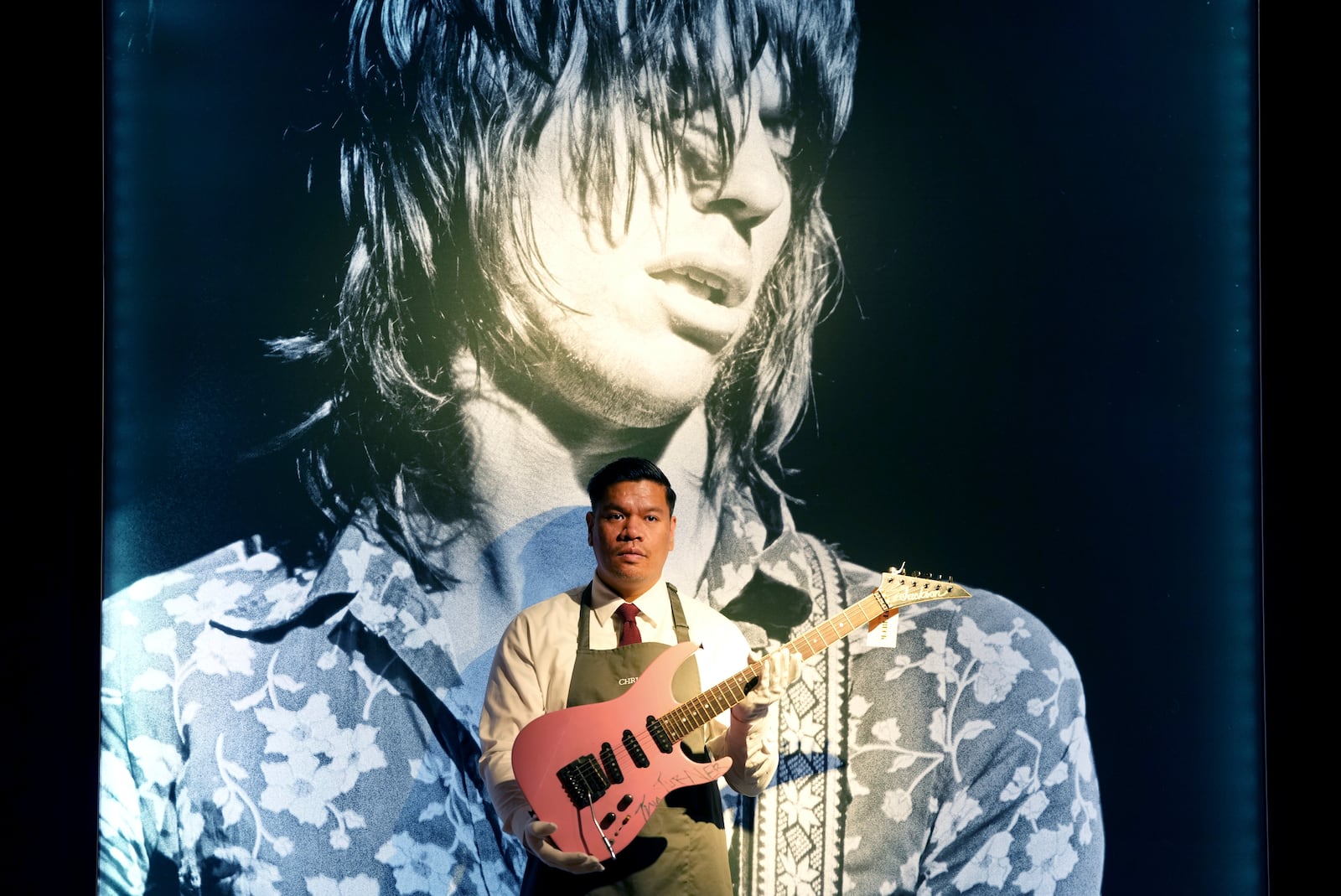 An art handler displays a Jackson, Glendora, California, 1983 a solid-body electric guitar, soloist, signed by Tina Turner, in London, Tuesday, Jan. 14, 2025, ahead of the pre-sale exhibition of Jeff Beck The Guitar Collection at Christie's auction rooms in London. (AP Photo/Kirsty Wigglesworth)