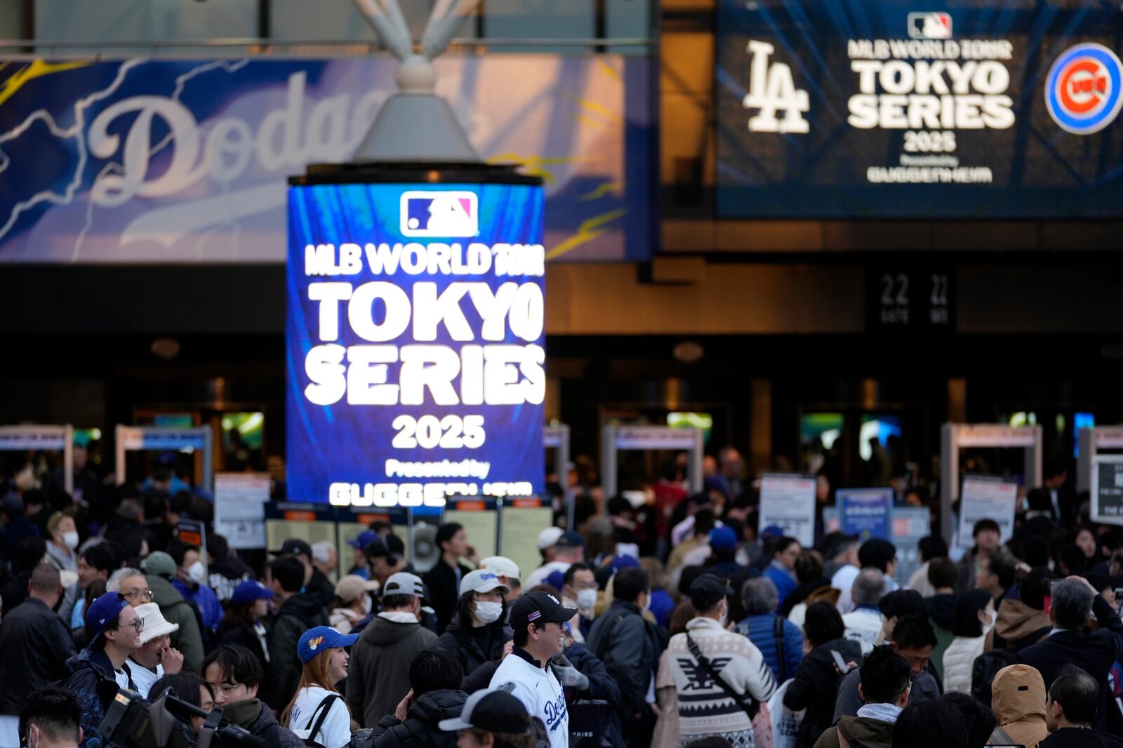 People walks around the entrance of Tokyo Dome, before an MLB Japan Series baseball game between the Los Angeles Dodgers and the Chicago Cubs at Tokyo Dome, in Tokyo, Tuesday, March 18, 2025. (AP Photo/Shuji Kajiyama)