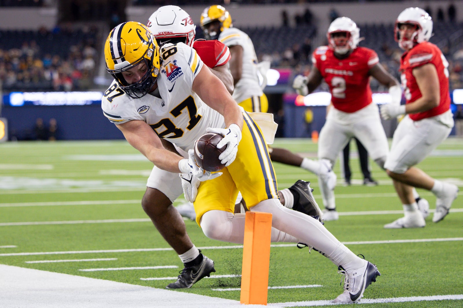 California tight end Jack Endries, left, is stopped short of the goal line by UNLV defensive back Jalen Catalon during the first half of the LA Bowl NCAA college football game Wednesday, Dec. 18, 2024, in Inglewood, Calif. (AP Photo/Ryan Sun)