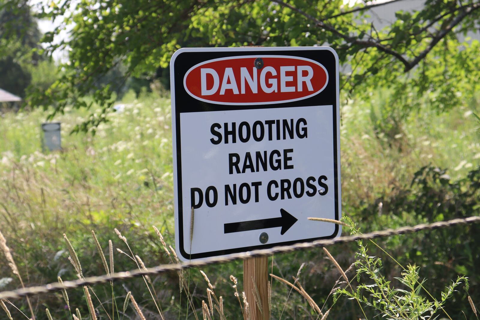 A shooting range warning sign was shot after a man in the 7000 block of Ballentine Pike fired several rounds during his neighbor's garage sale. Many bullets struck neighbor Amy James' storage barn and hay bales. JESSICA OROZCO/STAFF.