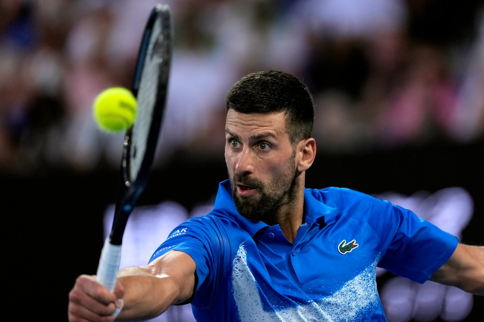 Novak Djokovic of Serbia returns a ball from Jiri Lehecka of the Czech Republic in their fourth round match at the Australian Open tennis championship in Melbourne, Australia, Sunday, Jan. 19, 2025. (AP Photo/Asanka Brendon Ratnayake)