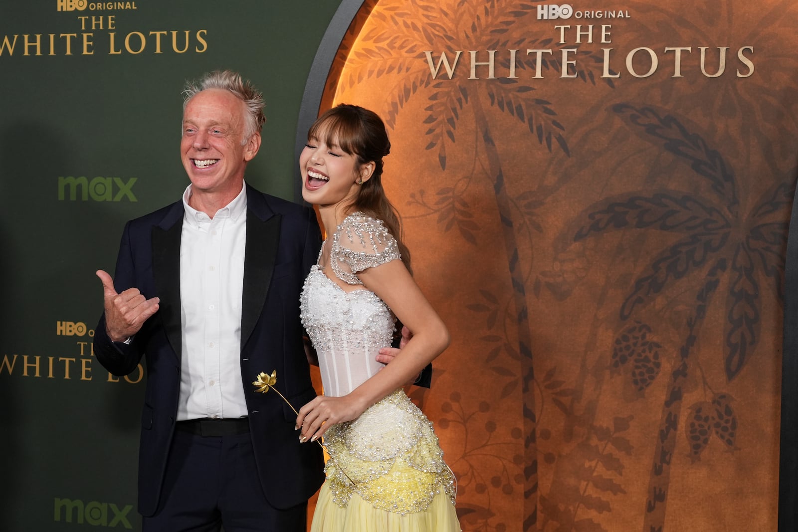 Mike White, left, makes the shaka hand gesture with Lisa at the season three premiere of "The White Lotus" on Monday, Feb. 10, 2025, at Paramount Theater in Los Angeles. (AP Photo/Chris Pizzello)