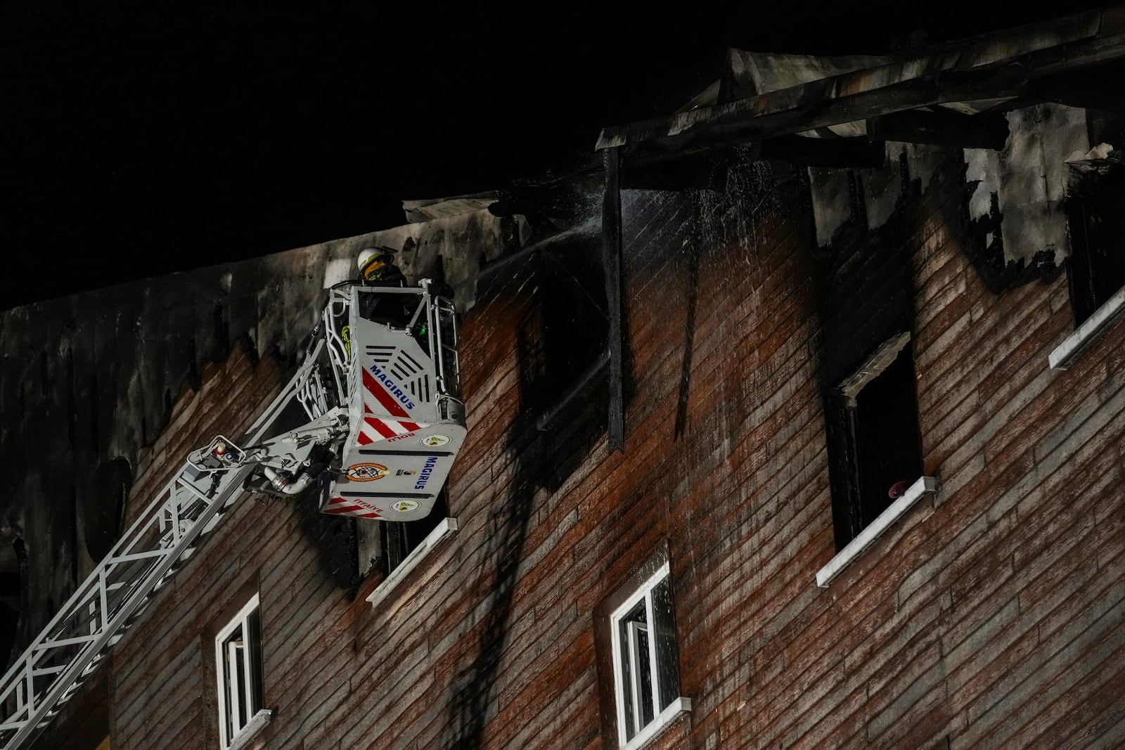 Firefighters work on the aftermath of a fire that broke out at a hotel in the ski resort of Kartalkaya, located in Bolu province, northwest Turkey, on Tuesday, Jan. 21, 2025. (AP Photo/Francisco Seco)