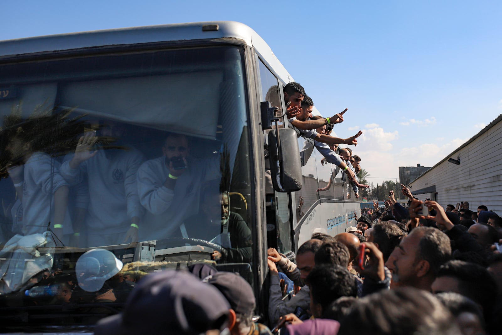 Freed Palestinian prisoners are greeted by a crowd as they arrive in the Gaza Strip after being released from an Israeli prison following a ceasefire agreement between Hamas and Israel in Khan Younis, Saturday, Feb. 1, 2025. (AP Photo/Jehad Alshrafi)