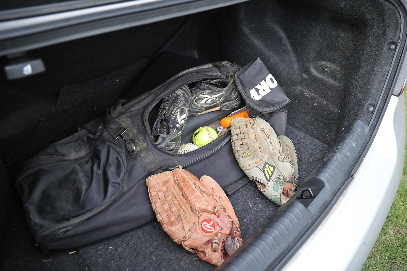 Rosa Tuttle's softball gear that's been in the trunk of her car since she was 17-years-old. BILL LACKEY/STAFF