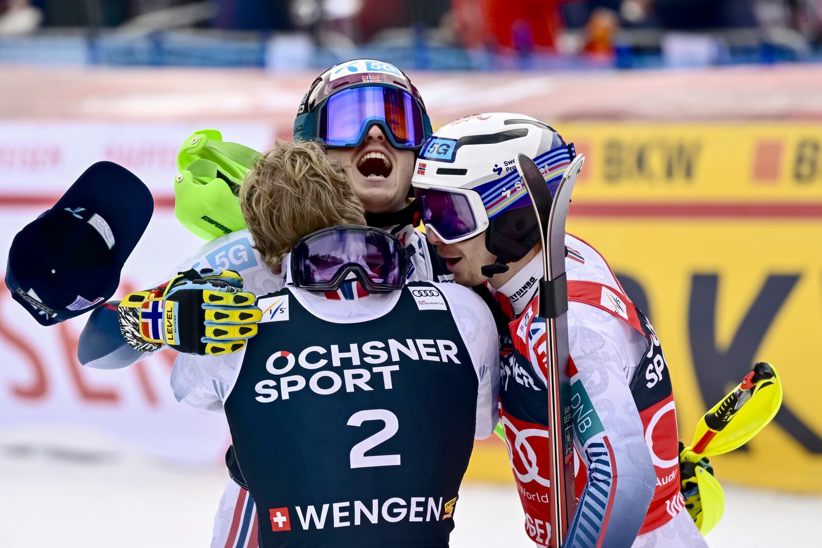 Norway's Atle Lie McGrath, center, winner of an alpine ski, men's World Cup slalom, celebrates with second-placed Norway's Timon Haugan, left, and third-placed Norway's Henrik Kristoffersen, in Wengen, Switzerland, Sunday, Jan. 19, 2025. (Jean-Christophe Bott/Keystone via AP)