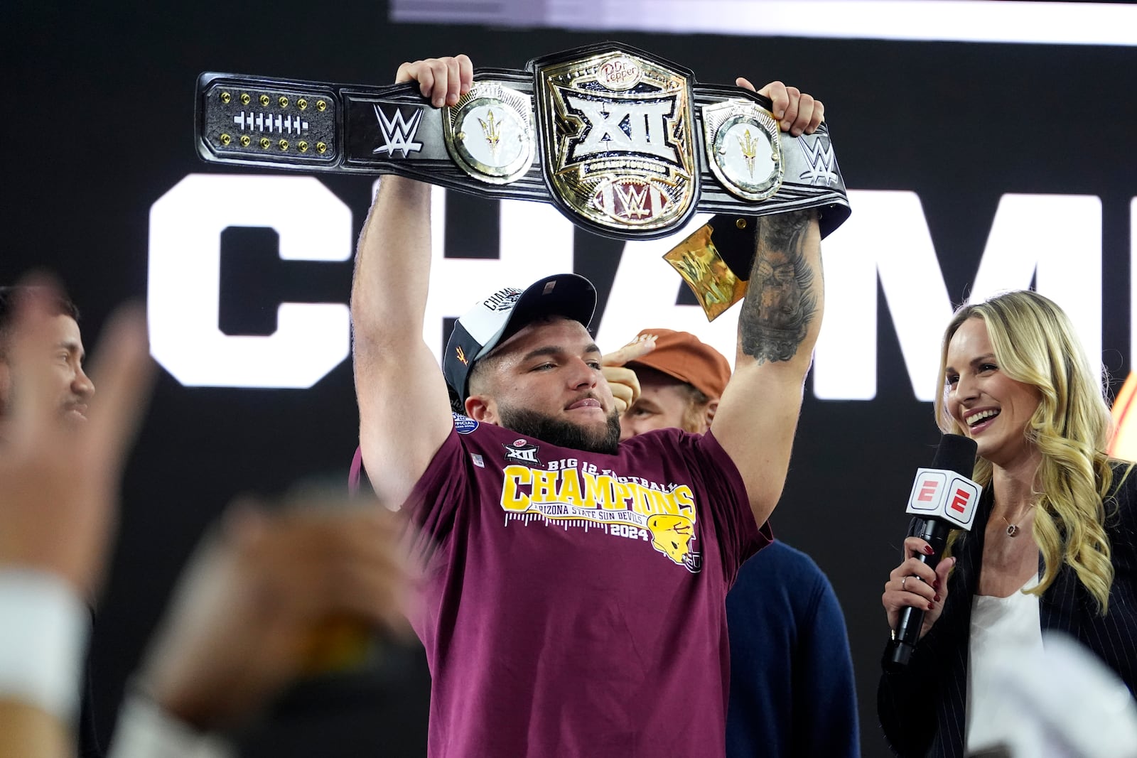 Arizona State running back Cam Skattebo (4) holds up the most valuable player trophy after the team's win against Iowa State in the Big 12 Conference championship NCAA college football game, in Arlington, Texas, Saturday Dec. 7, 2024. (AP Photo/Julio Cortez)