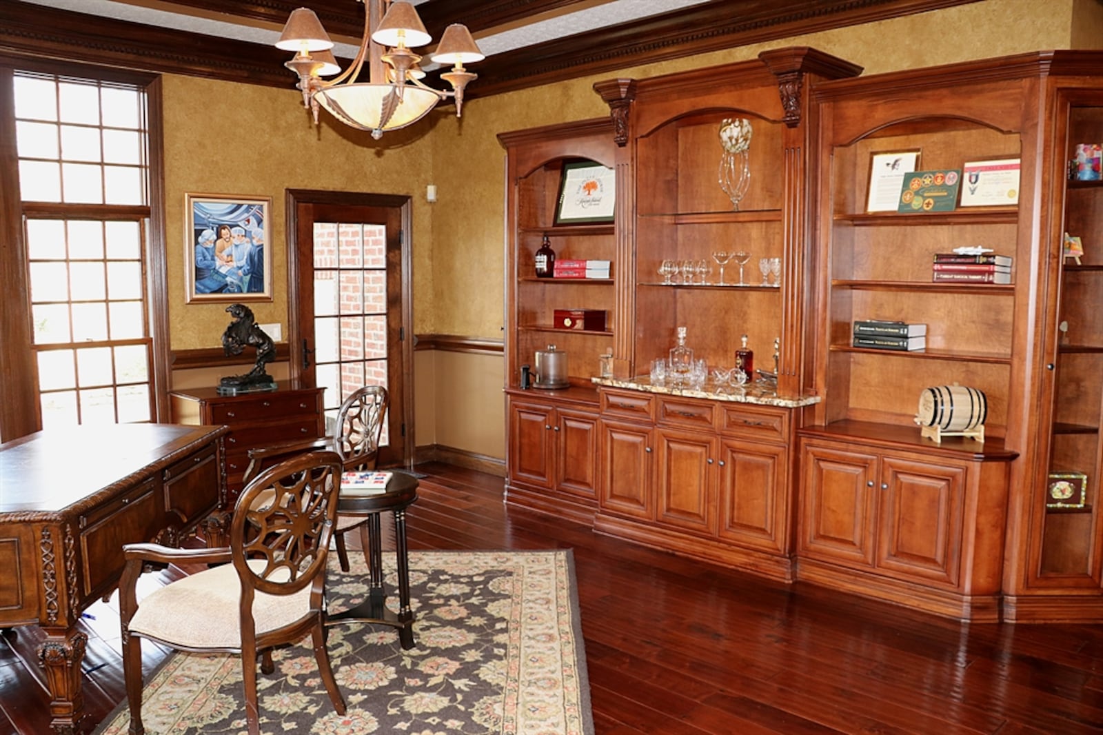 A glass door in the study opens out to the side concrete driveway and boulder-steps to the backyard.